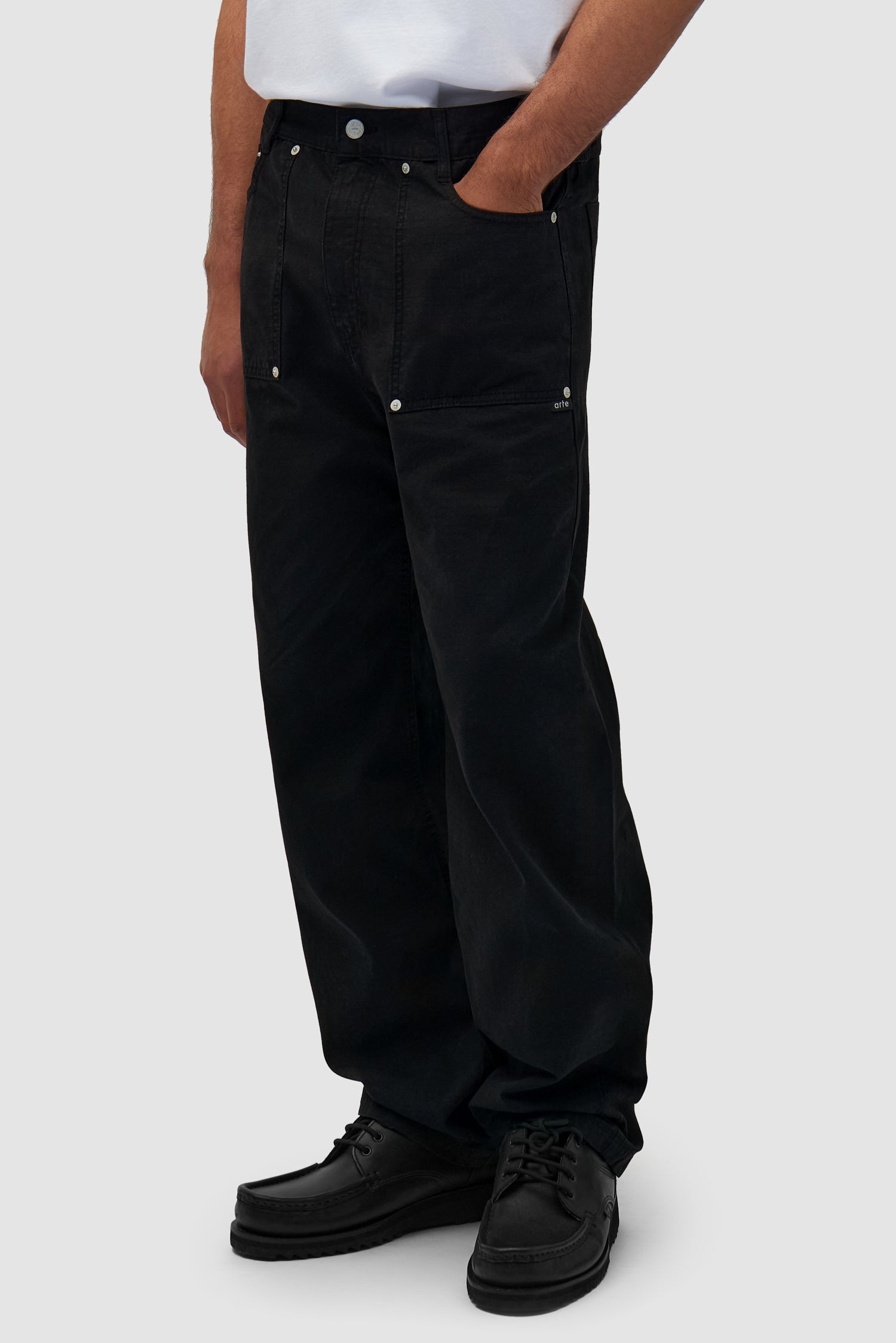 Ripstop Fabric Pants in Black worn by a model, half-body side view