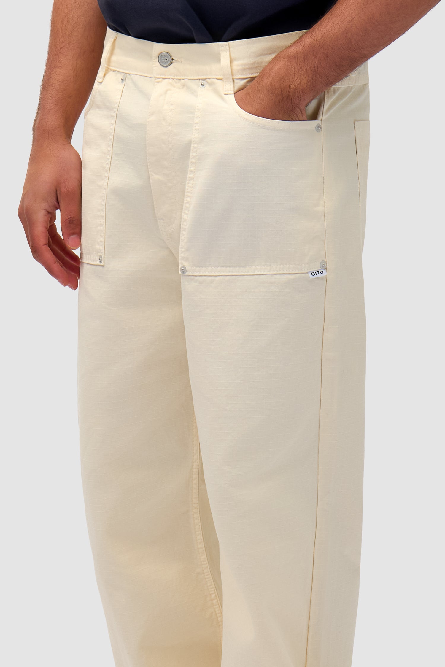 Ripstop Fabric Pants in Cream worn by a model, full-body back view