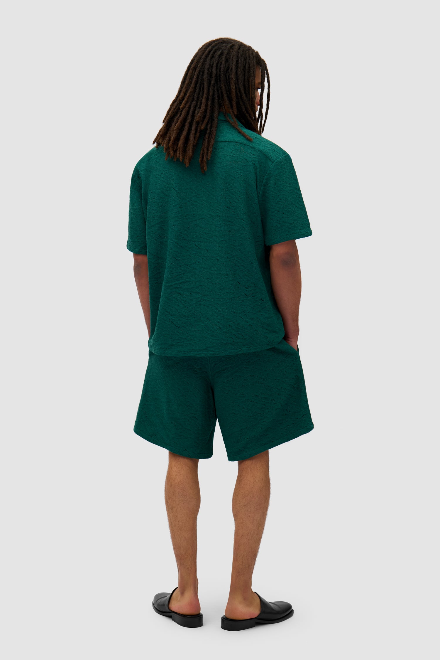 Crochet Shirt in Green worn by a model, full-body back view