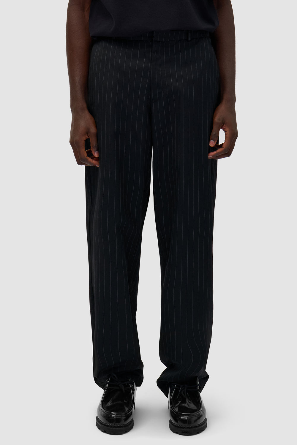 Suit Pants in Black worn by a model, half-body front view