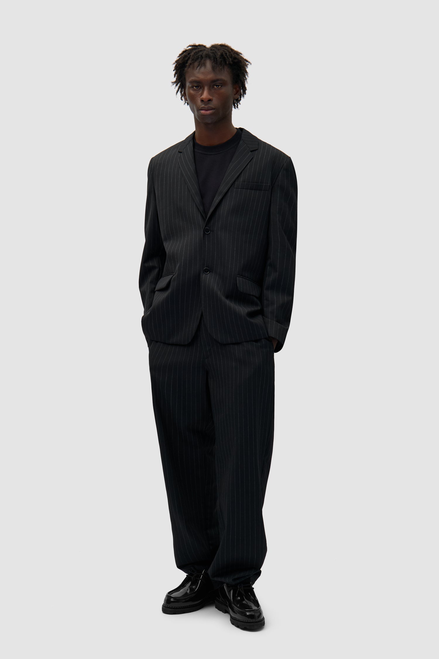 Suit Pants in Black worn by a model, full-body front view