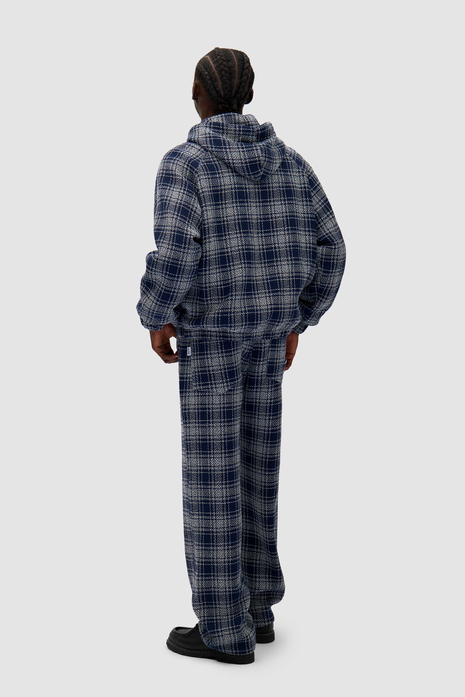 Square Fabric Pants in Plaid worn by a model, full-body back view