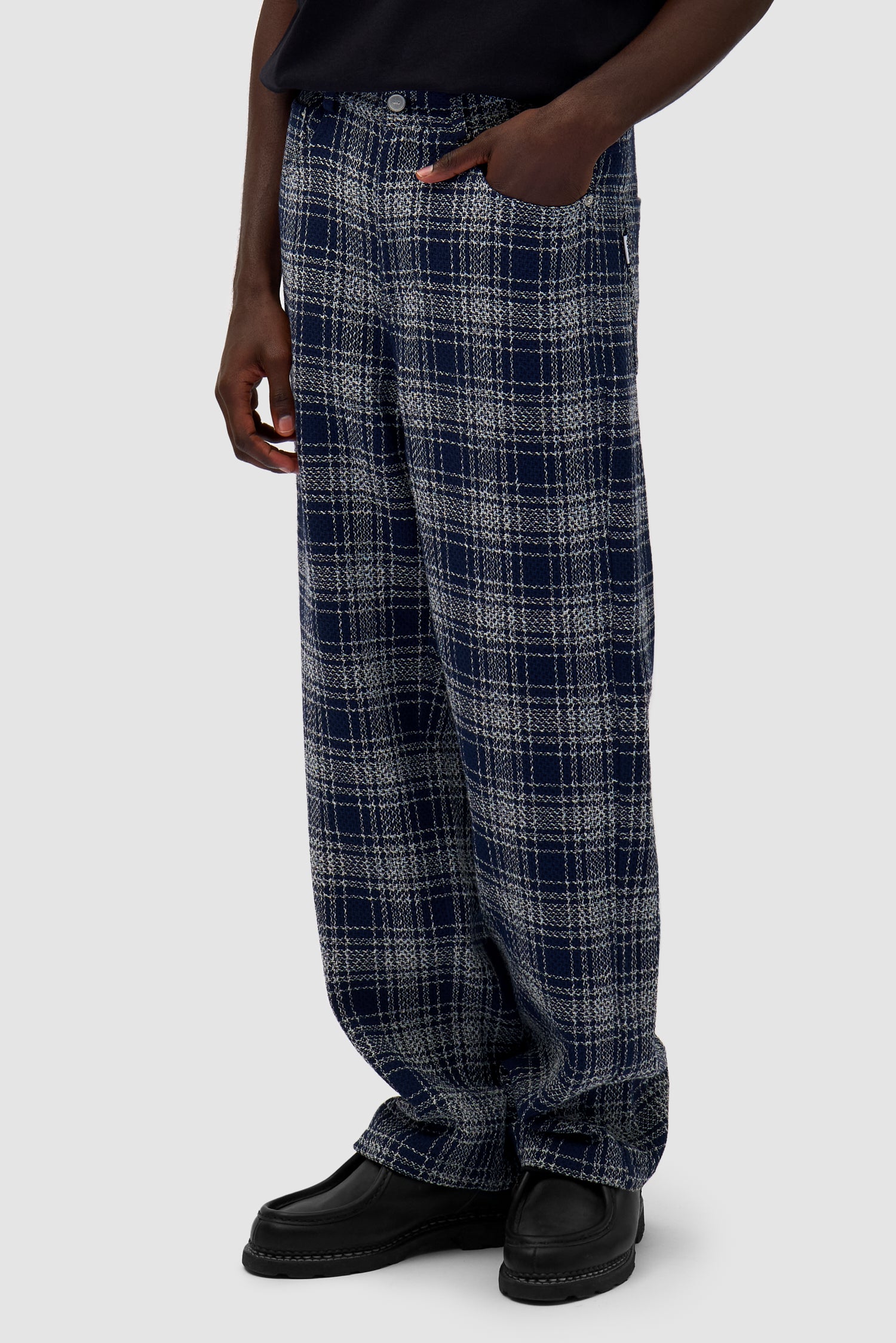 Square Fabric Pants in Plaid worn by a model, half-body side view