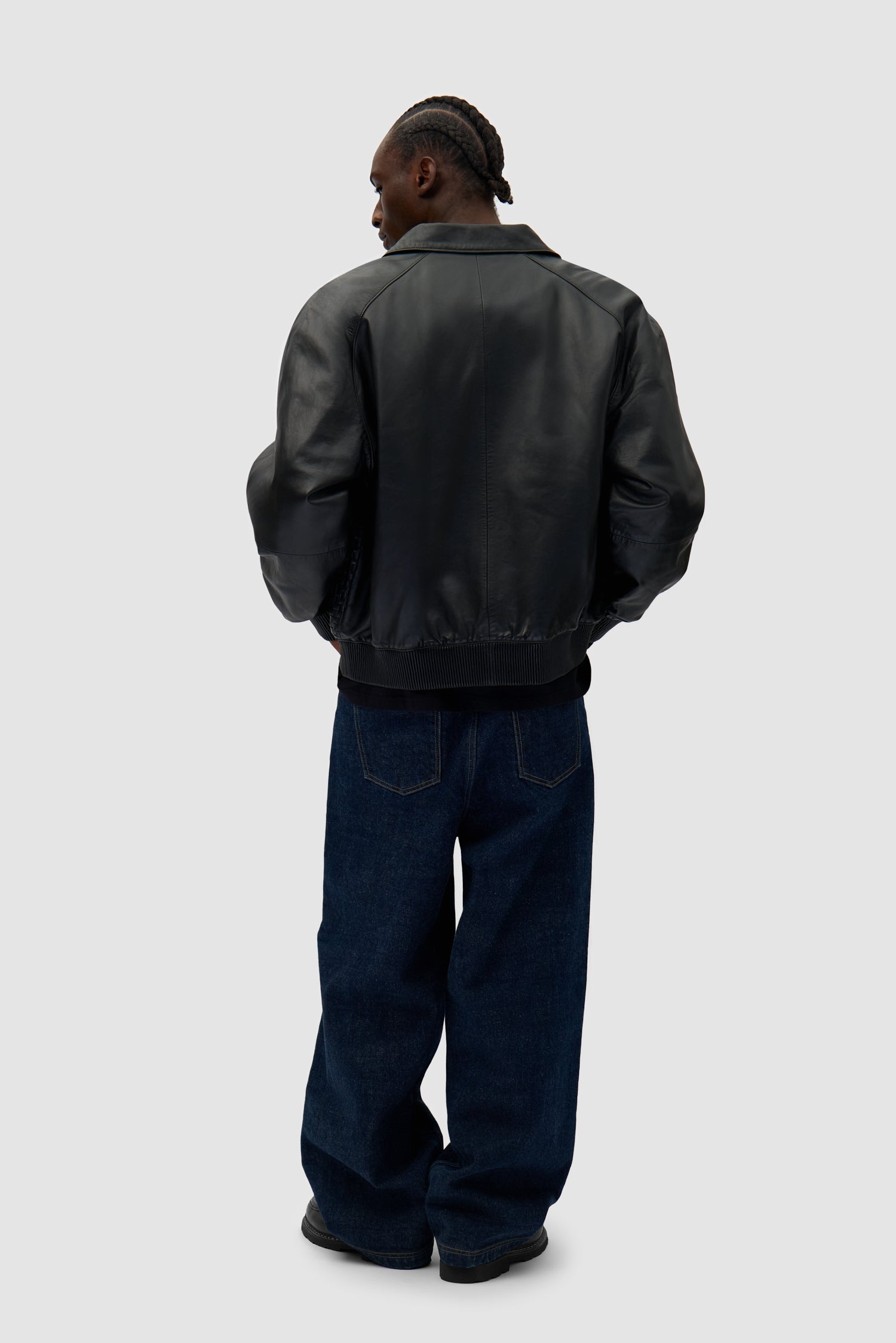 Square Leather Jacket in Black worn by a model, full-body back view