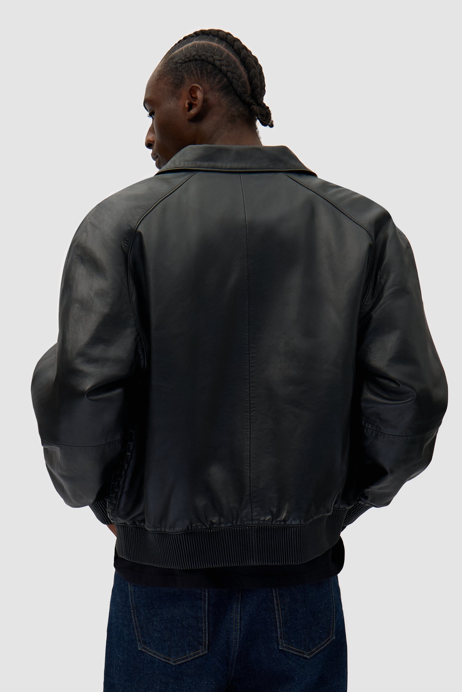 Square Leather Jacket in Black worn by a model, half-body back view