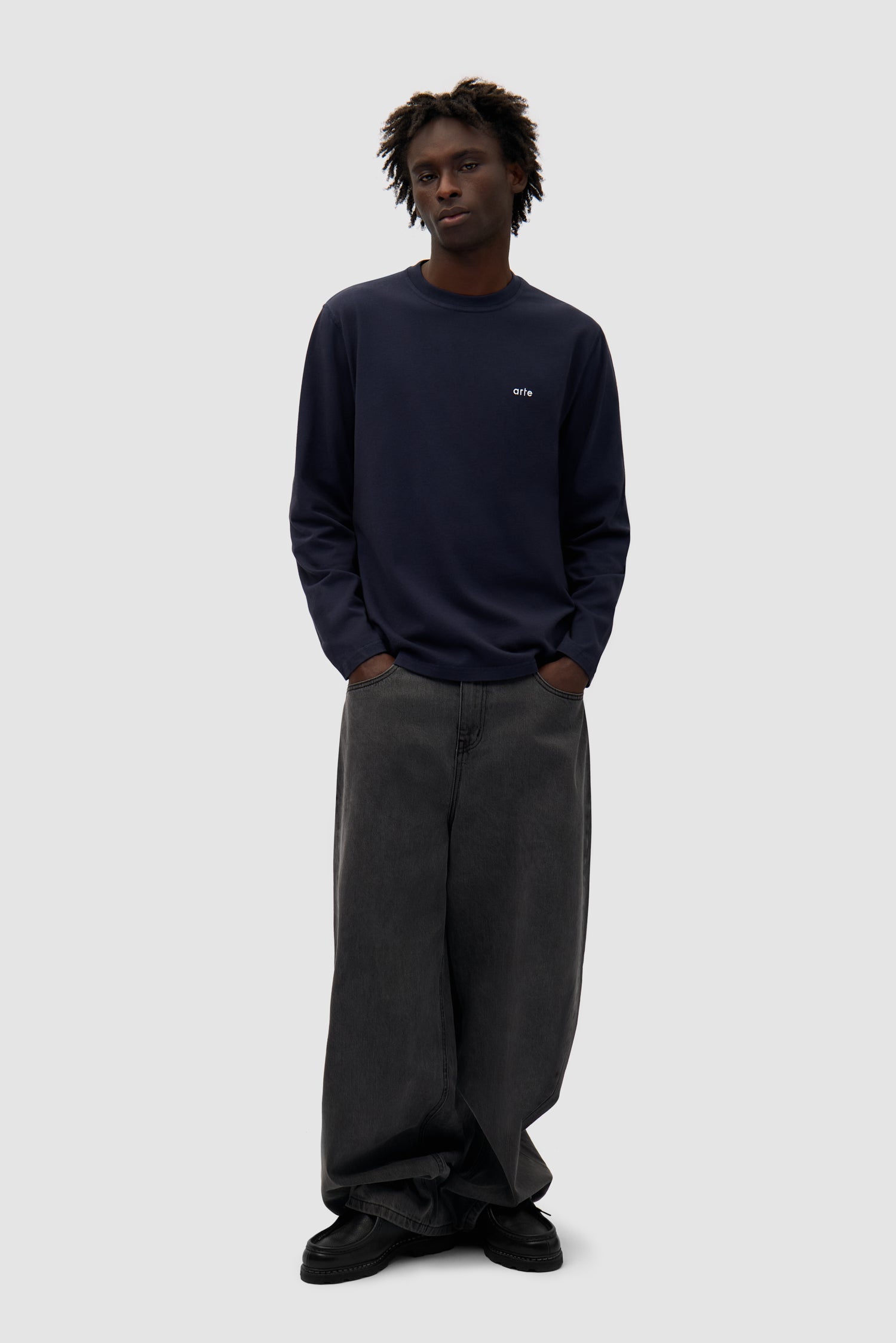 Good Energy Longsleeve in Navy worn by a model, full-body side view