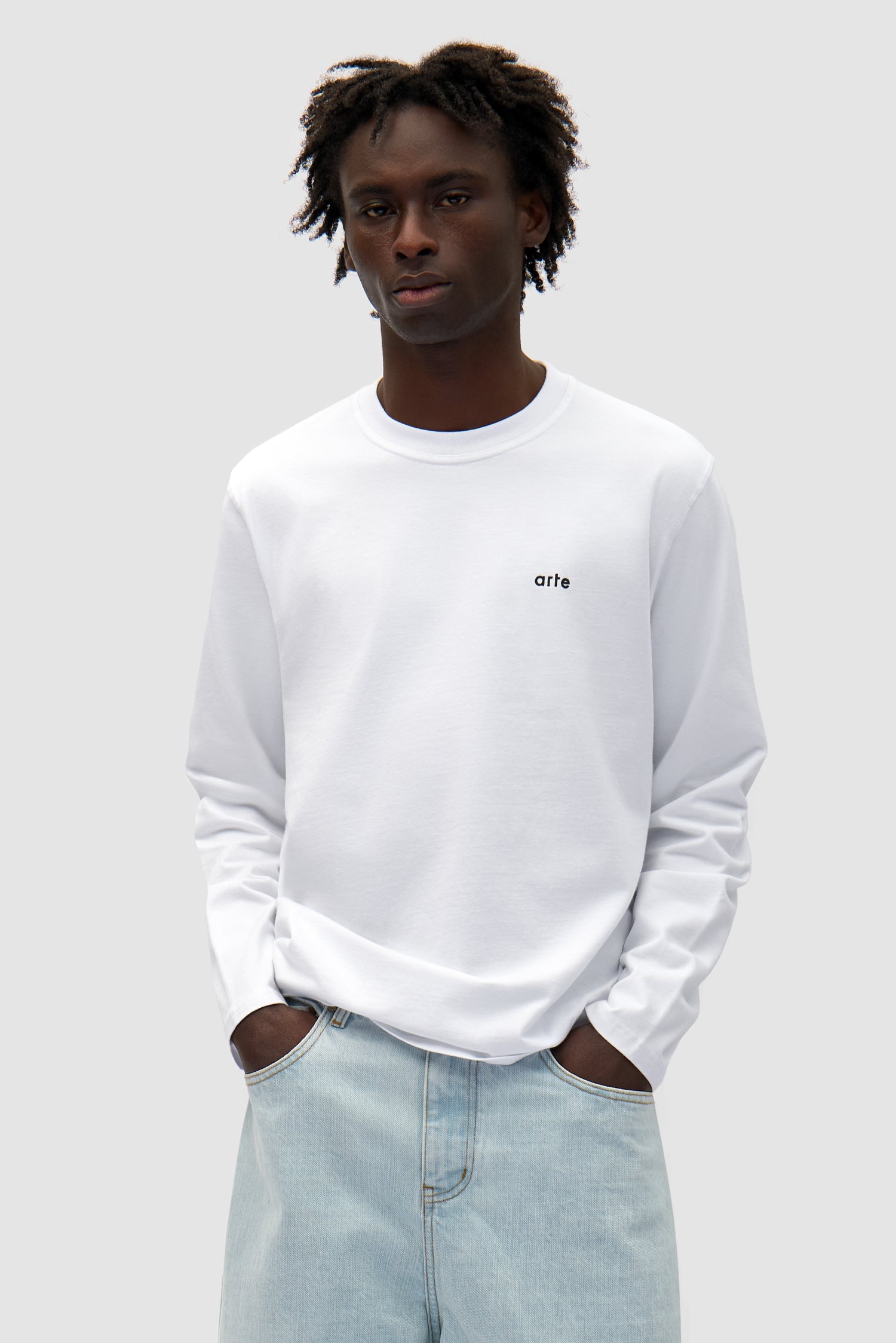 Good Energy Longsleeve in White worn by a model, half-body front view