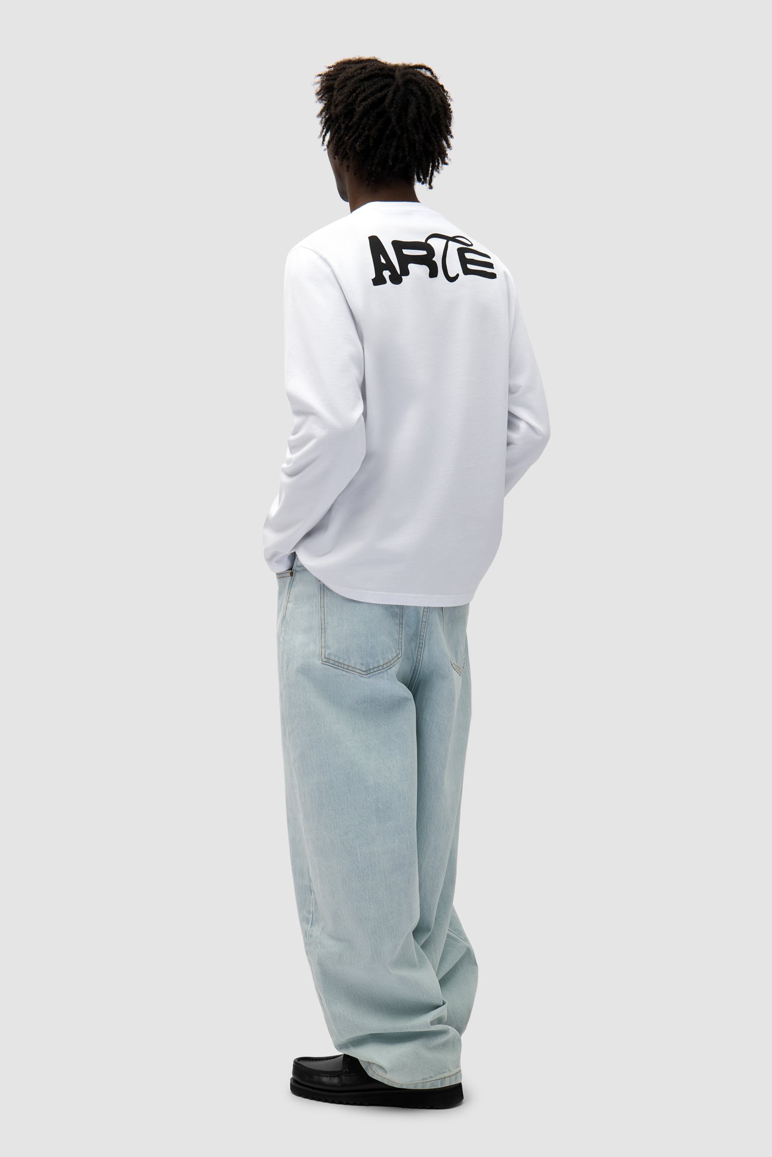 Good Energy Longsleeve in White worn by a model, full-body back view