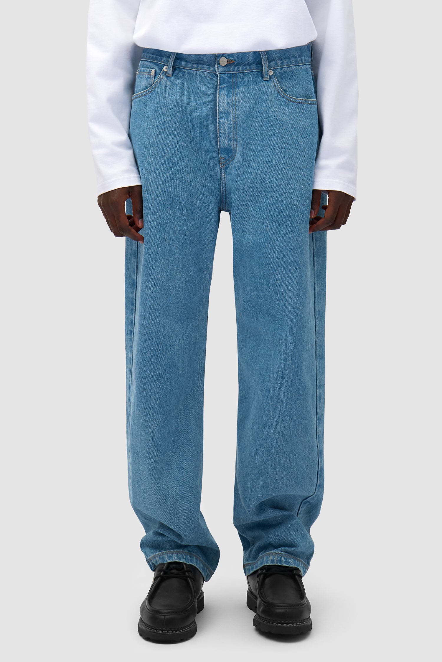 Bird Denim Pants in Bleach worn by a model, half-body back view