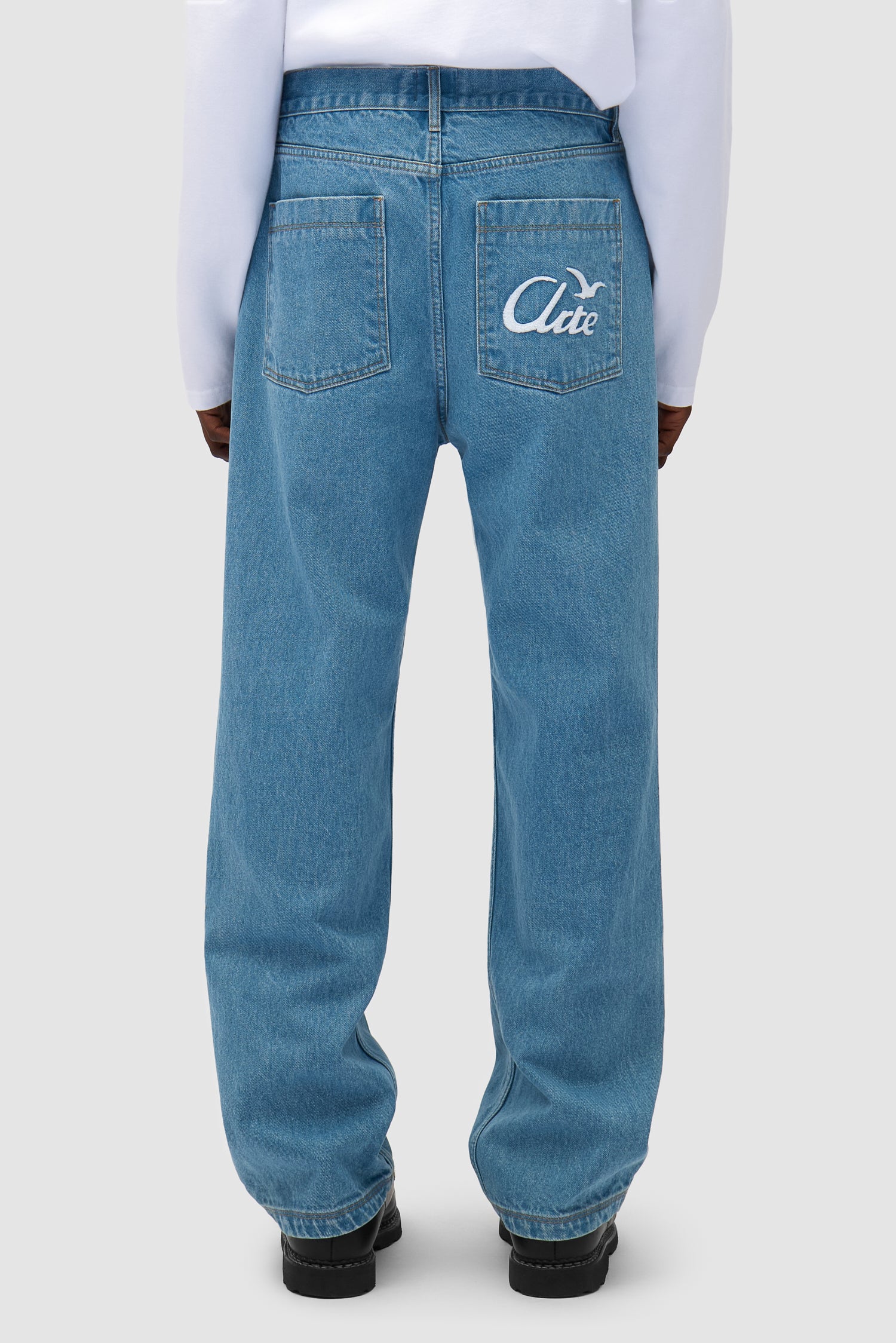 Bird Denim Pants in Bleach worn by a model, half-body front view