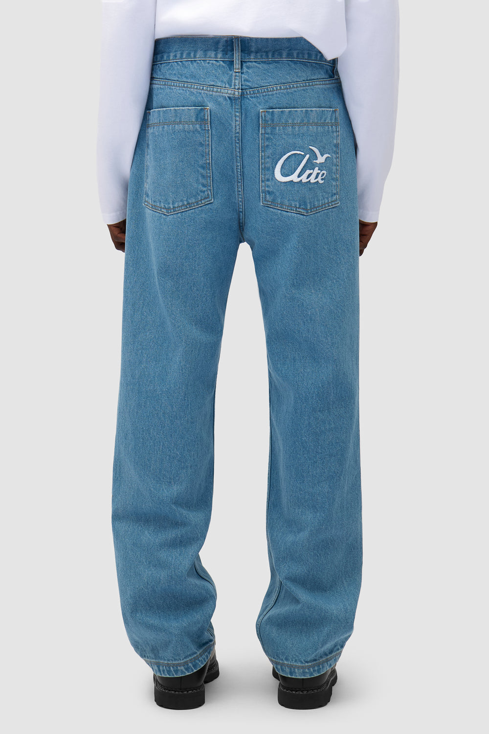 Bird Denim Pants in Bleach worn by a model, half-body front view