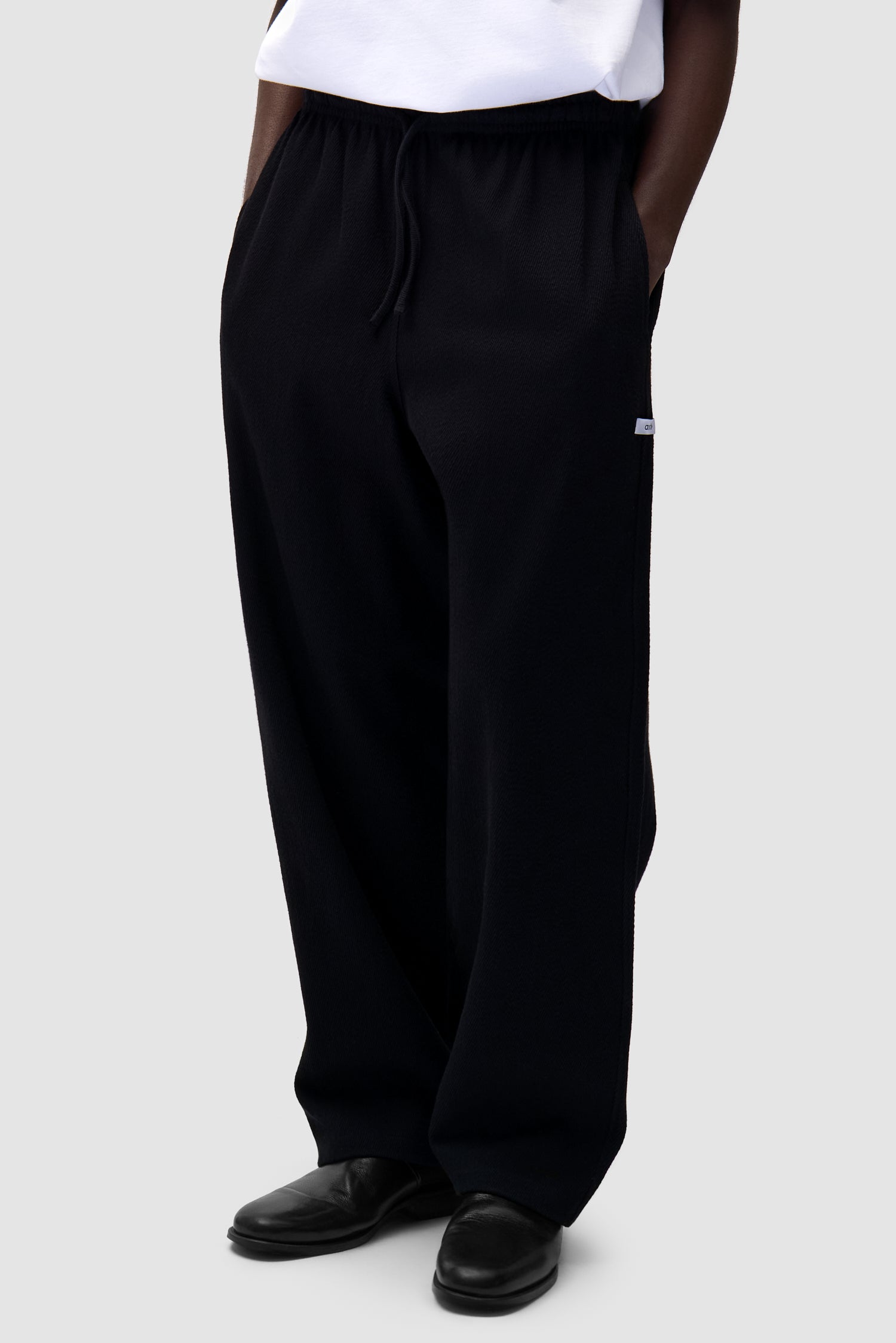 Detail view of Label Pants in Black
