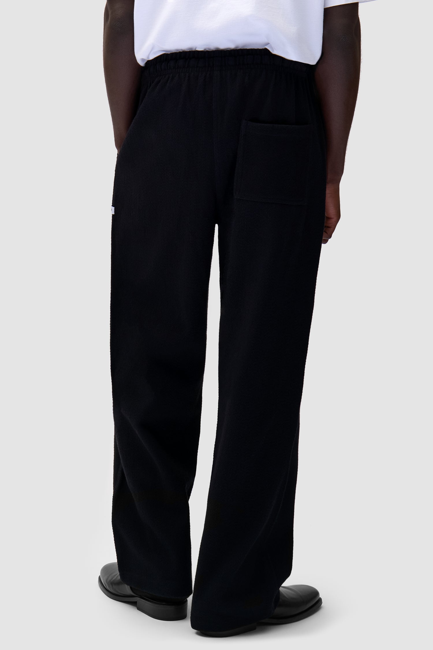 Label Pants in Black worn by a model, half-body side view