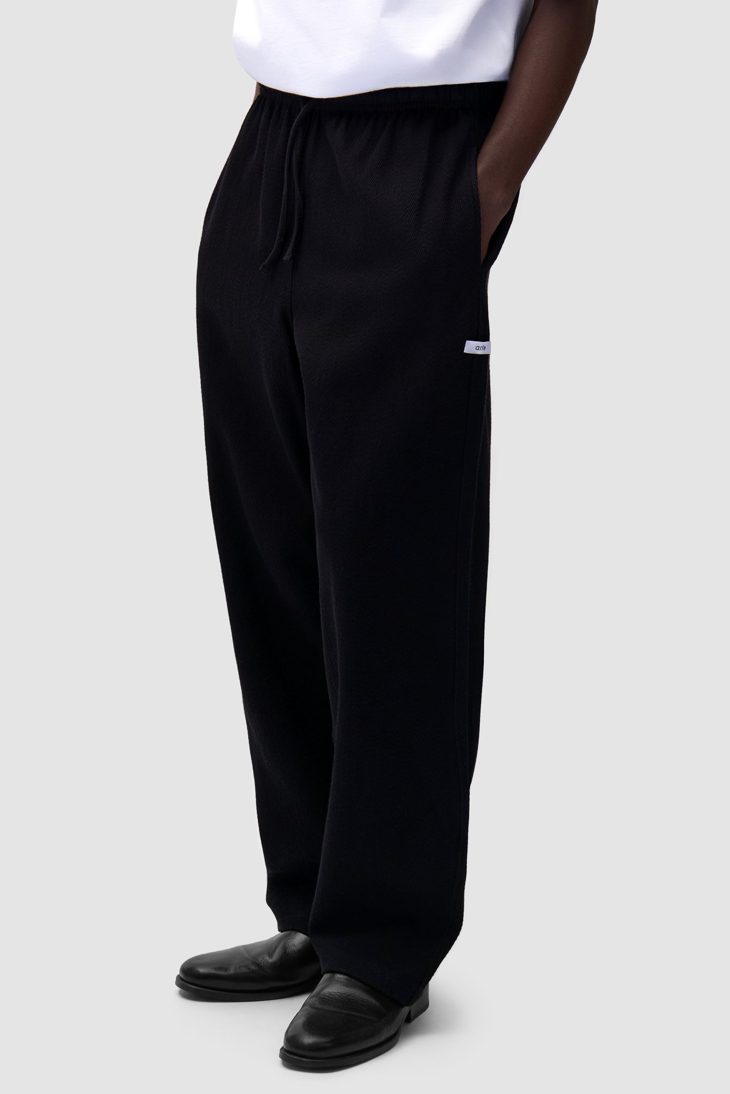 Label Pants in Black worn by a model, half-body front view