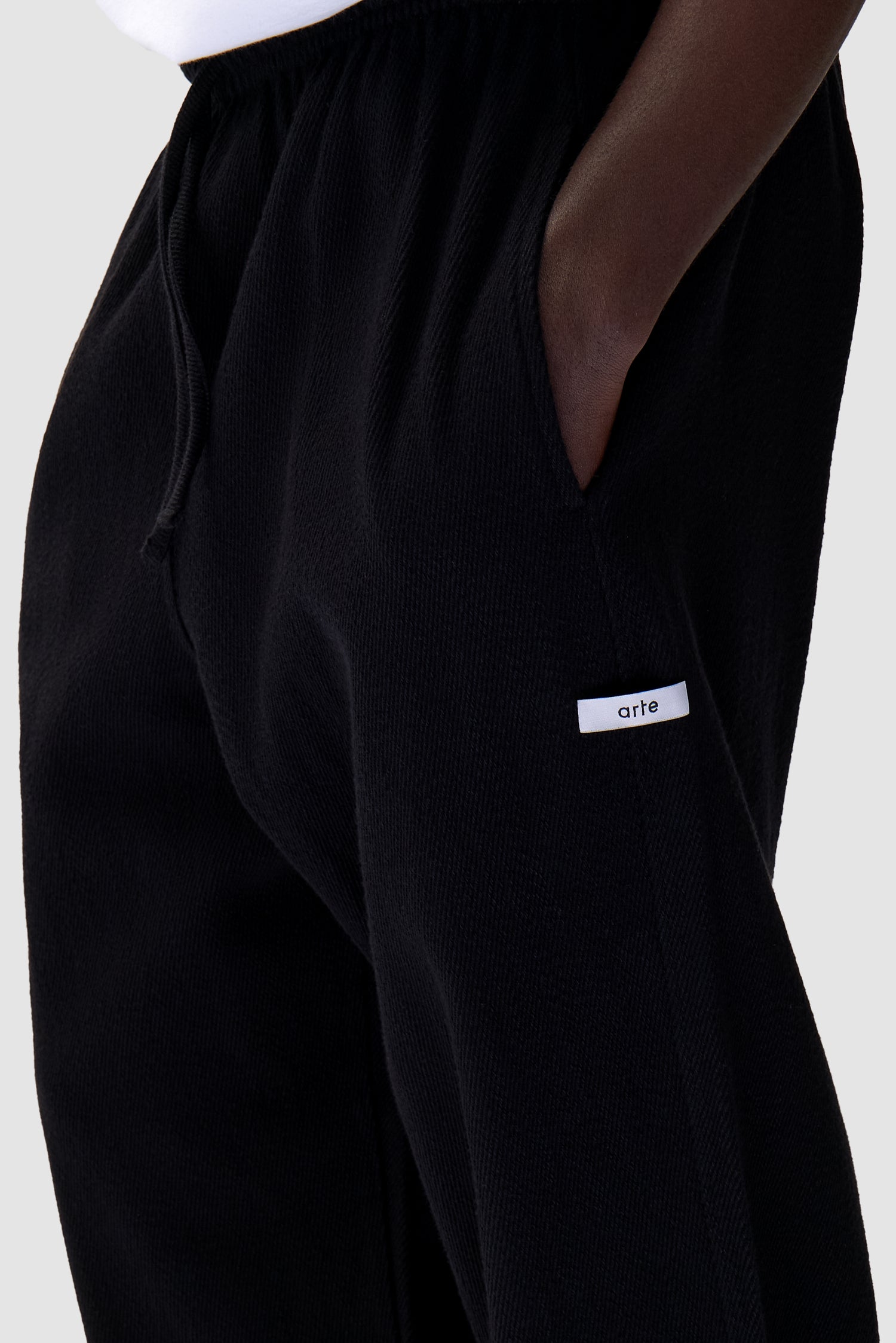 Label Pants in Black worn by a model, full-body back view