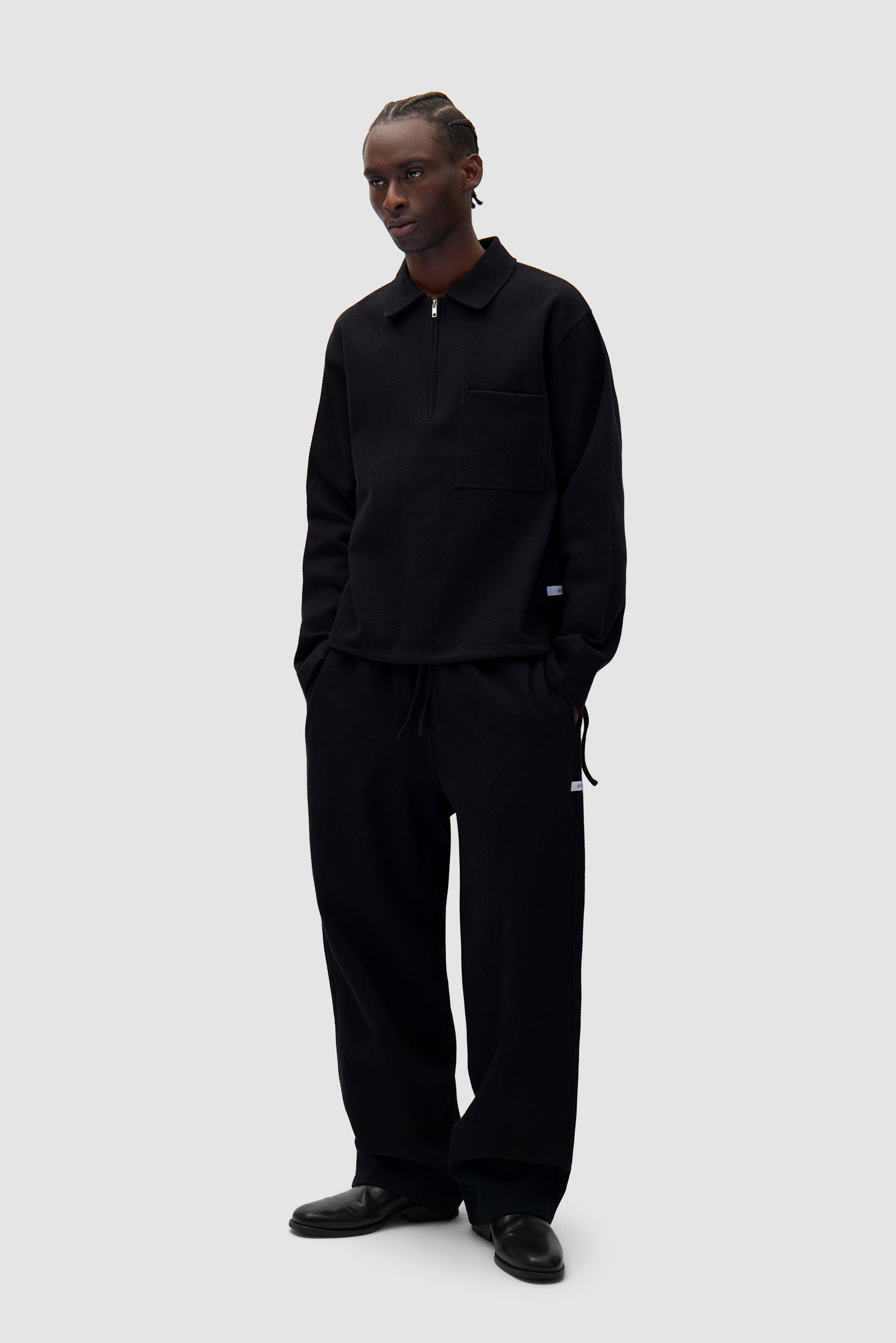 Label Pants in Black worn by a model, half-body back view