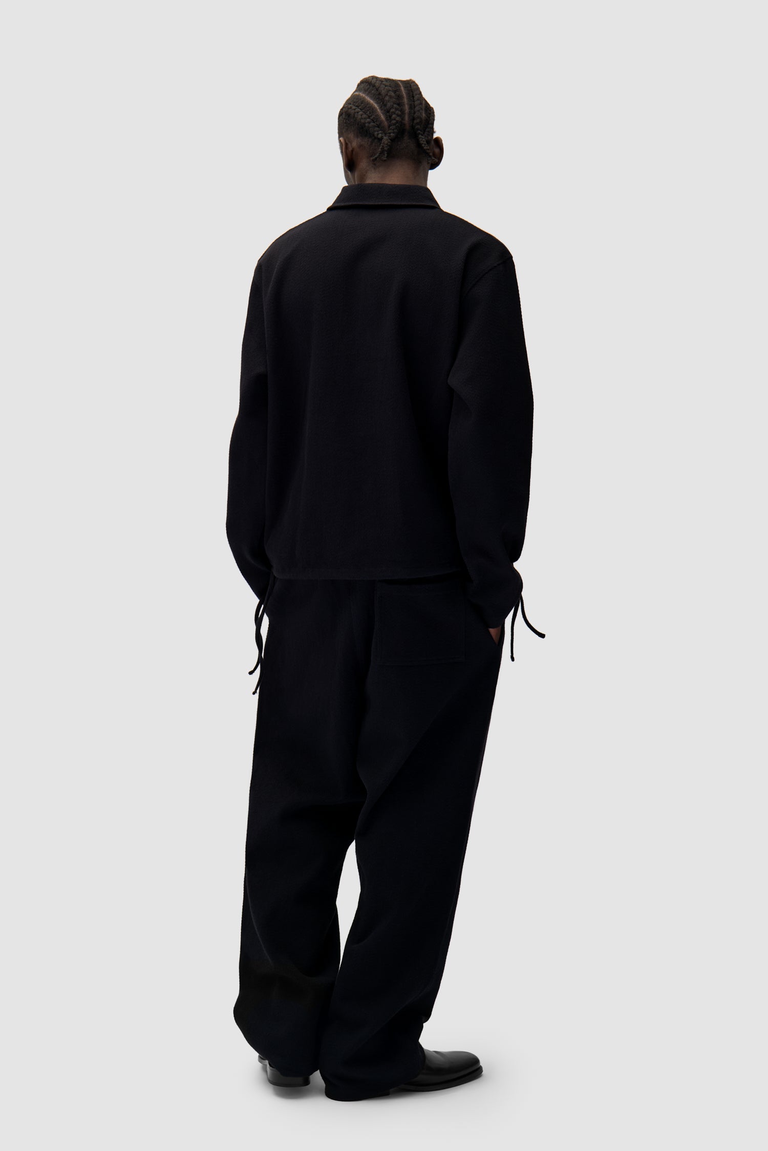 Label Pants in Black worn by a model, full-body side view