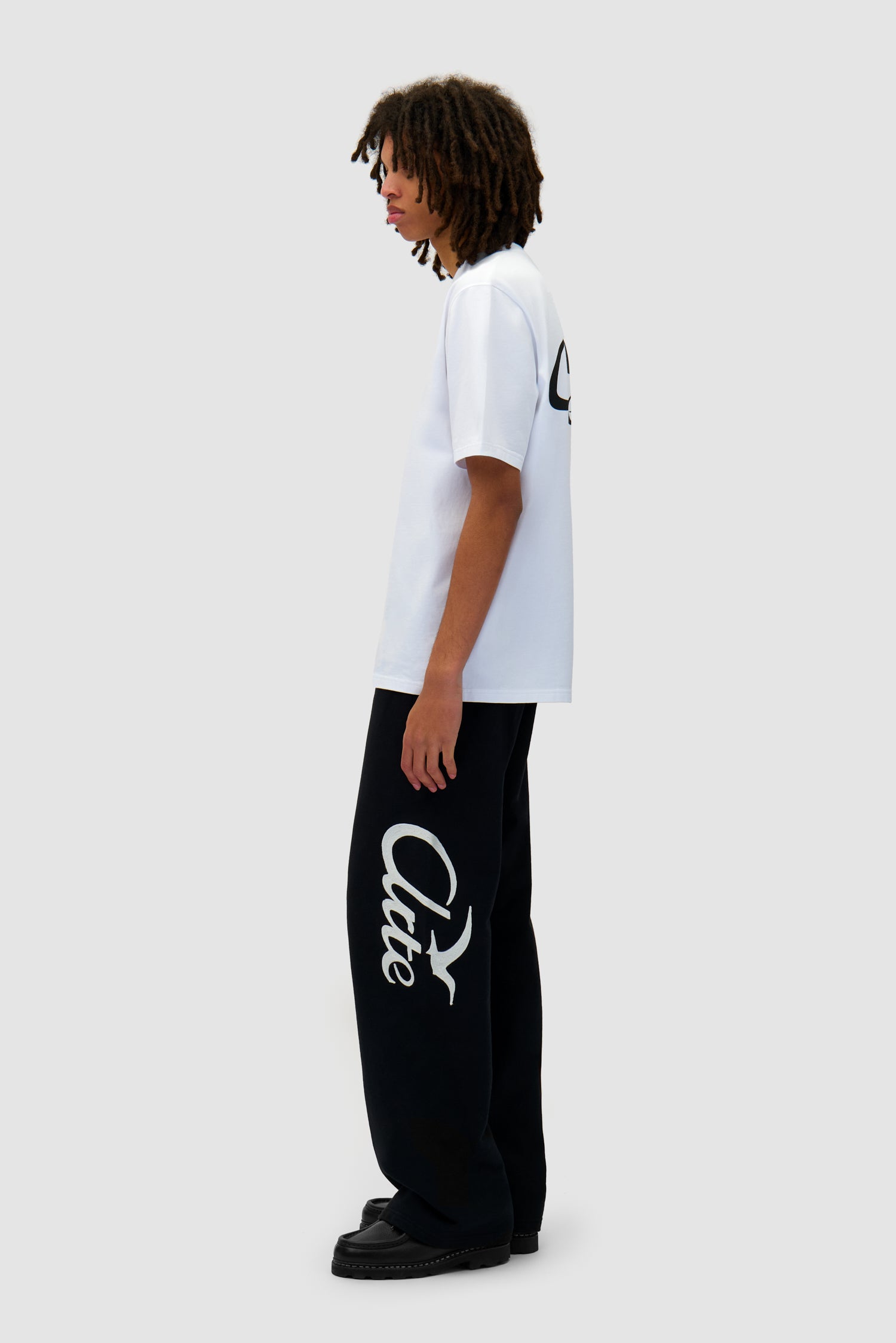 Jogger Pants in Black worn by a model, full-body side view