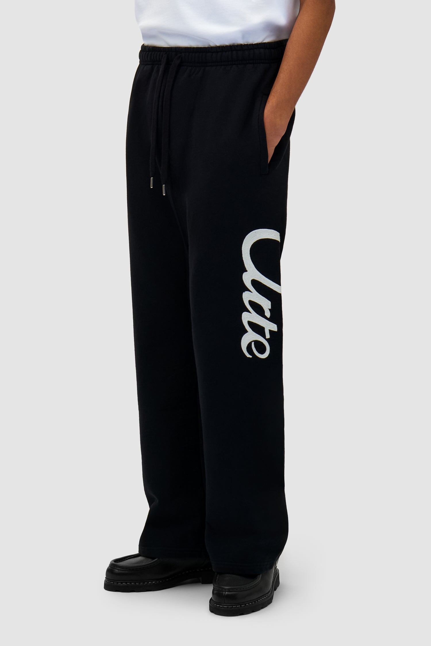 Jogger Pants in Black worn by a model, half-body side view