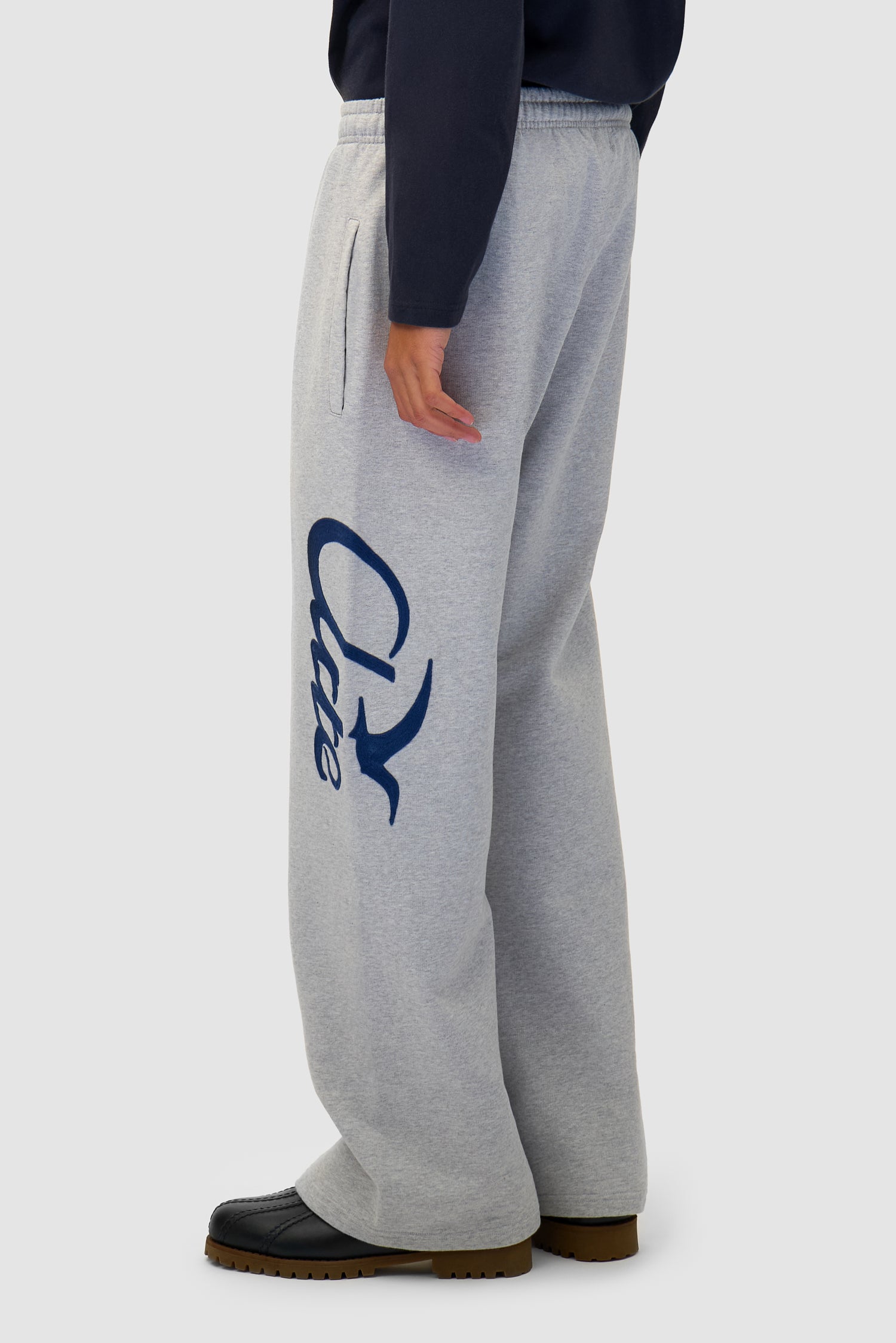 Jogger Pants in Grey worn by a model, half-body back view