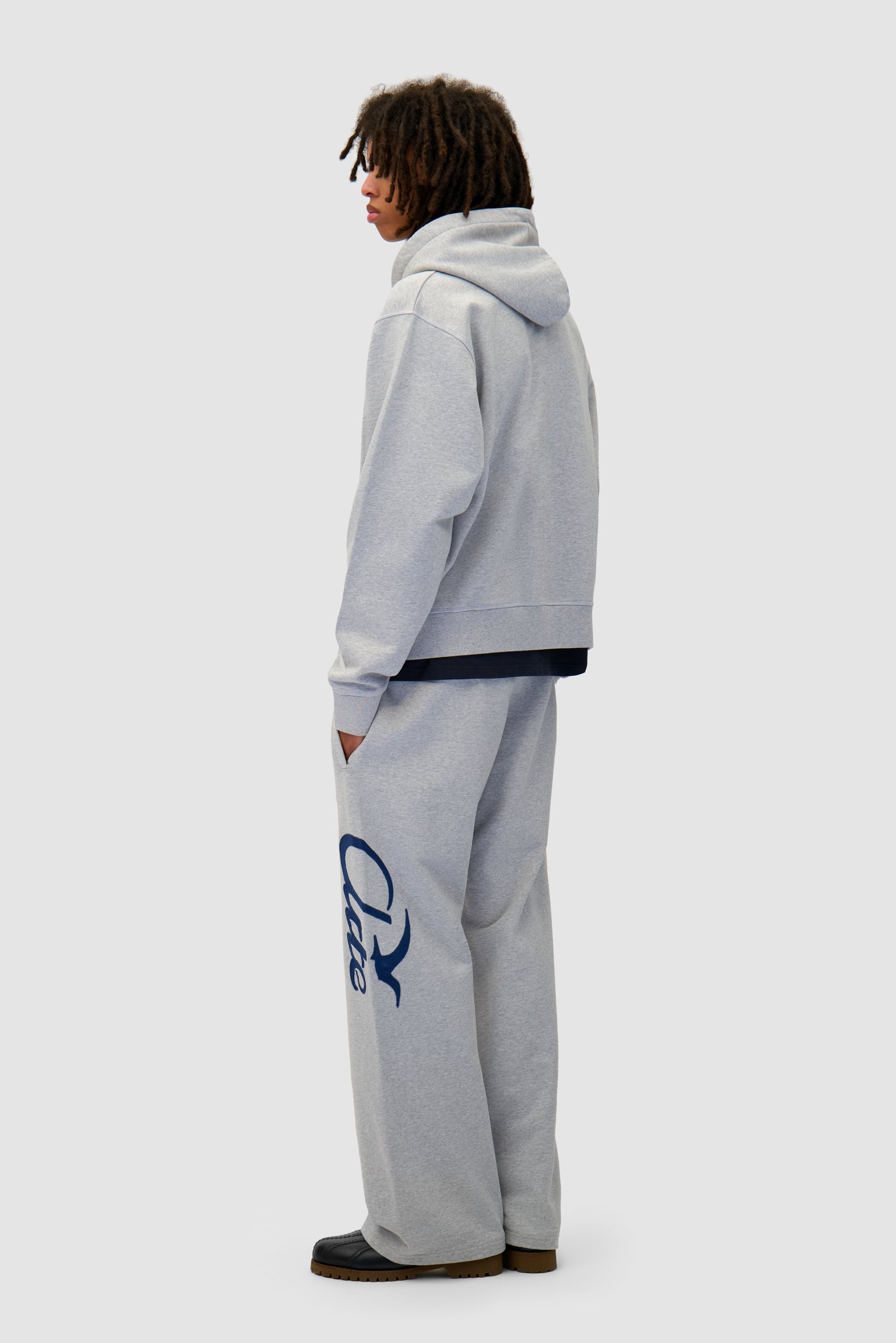 Jogger Pants in Grey worn by a model, full-body back view