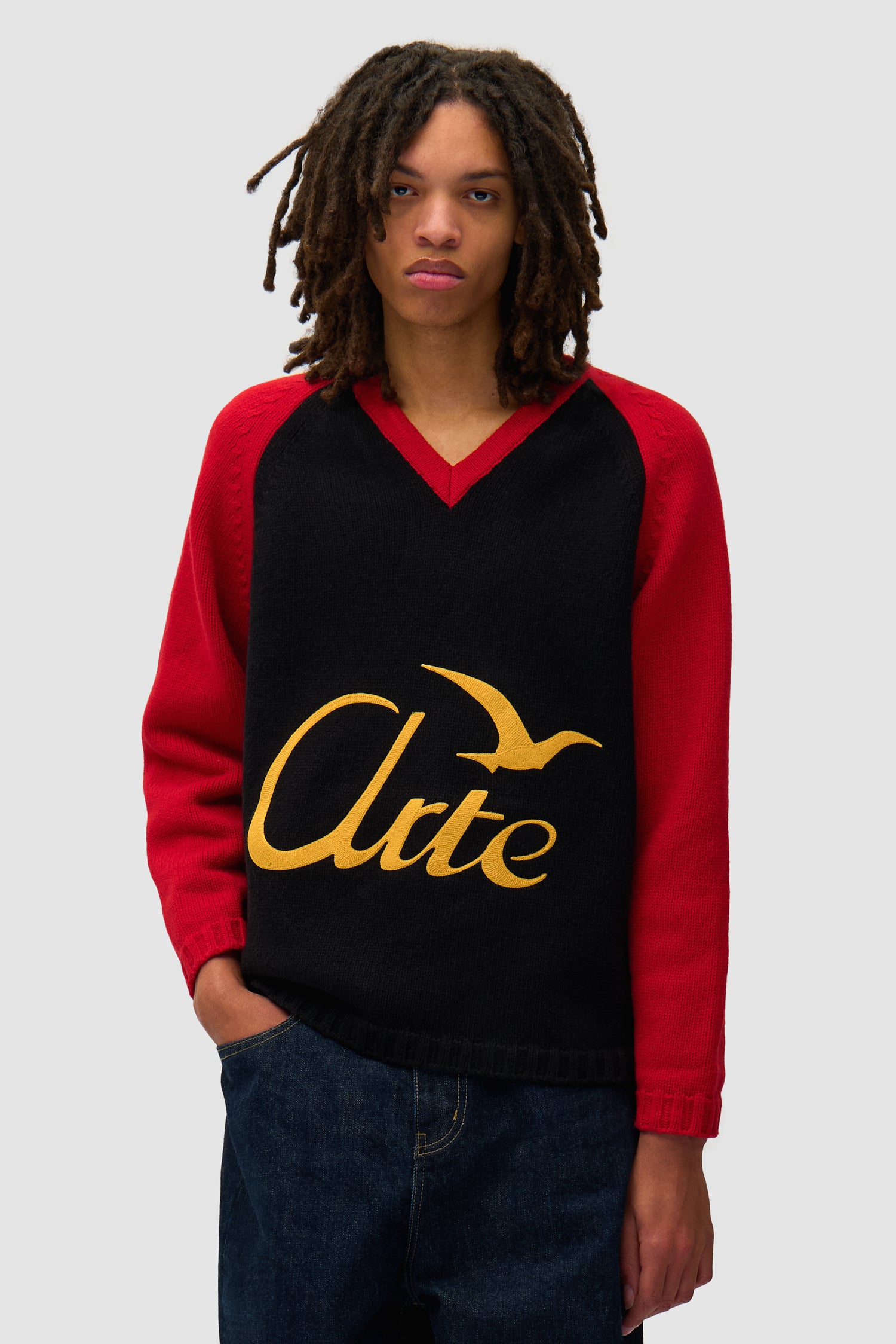 Knitted Longsleeve in Black/Red worn by a model, half-body front view