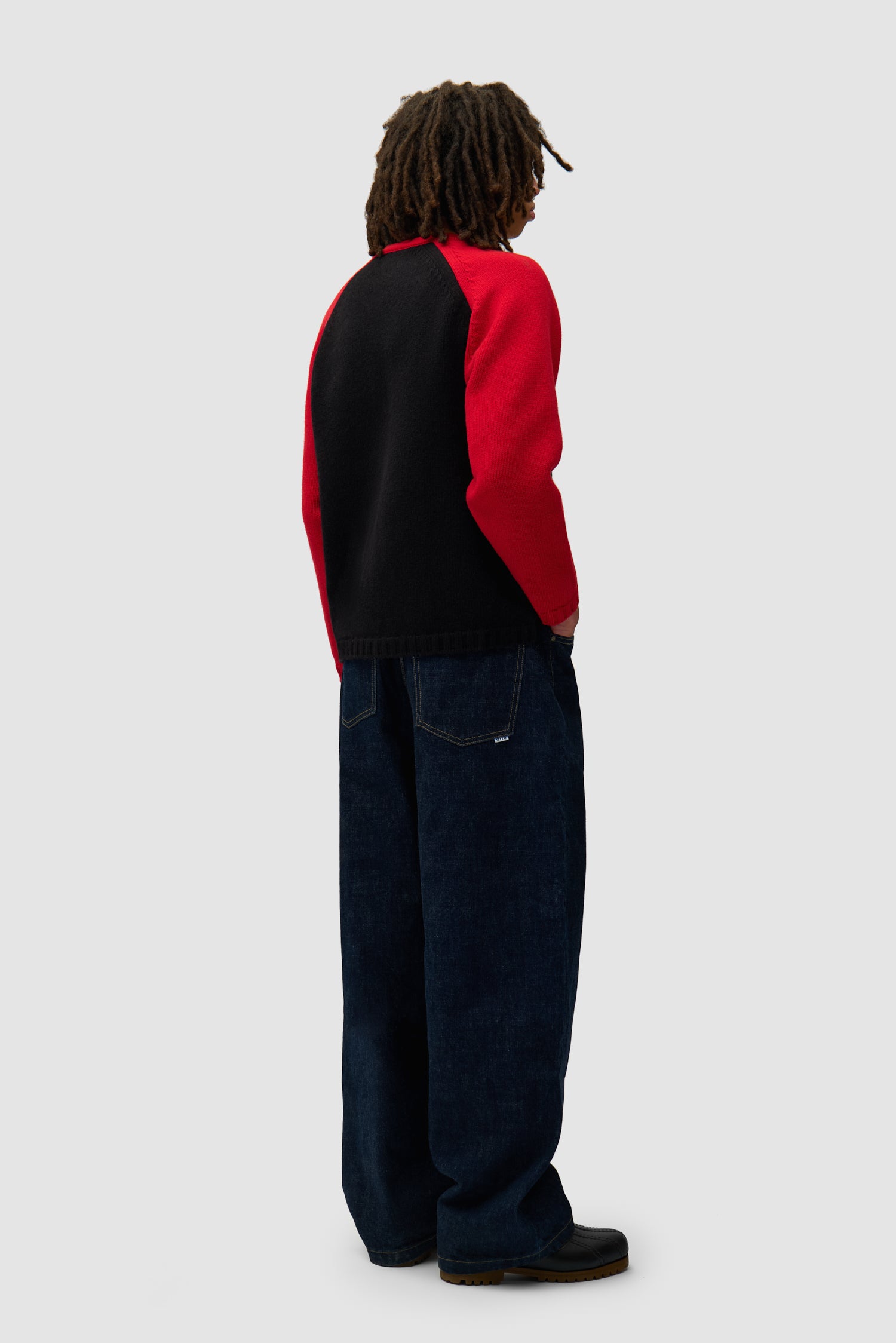 Knitted Longsleeve in Black/Red worn by a model, full-body back view