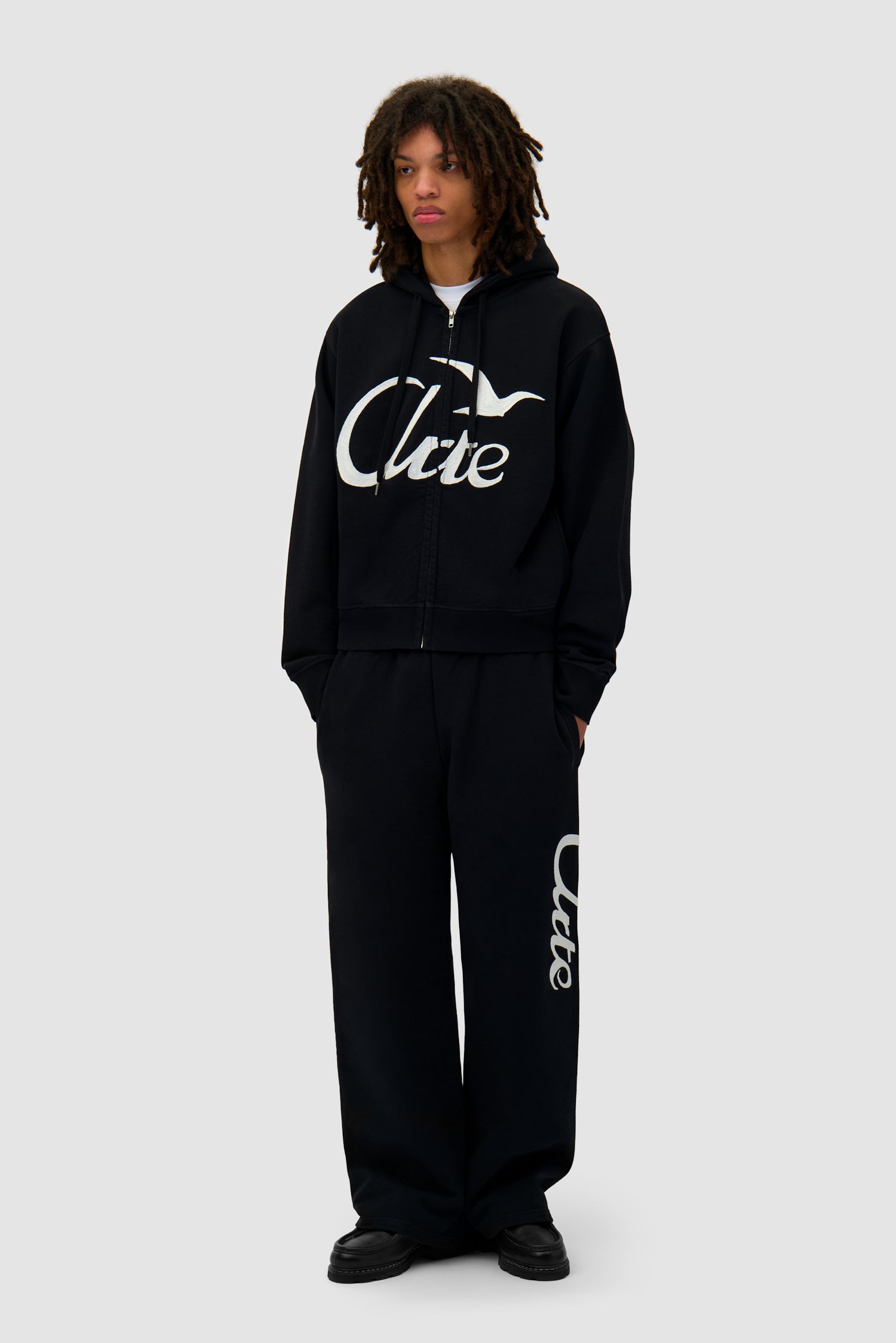 Zipper Hoodie in Black worn by a model, full-body front view