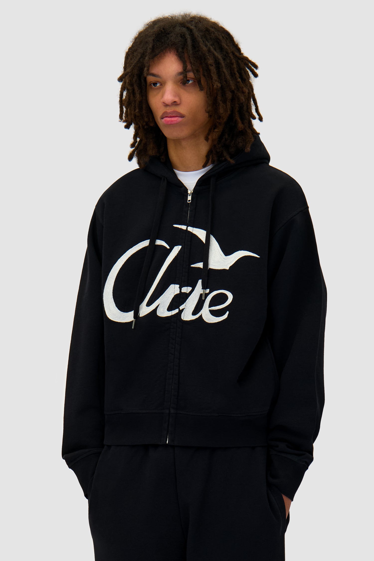 Zipper Hoodie in Black worn by a model, half-body front view