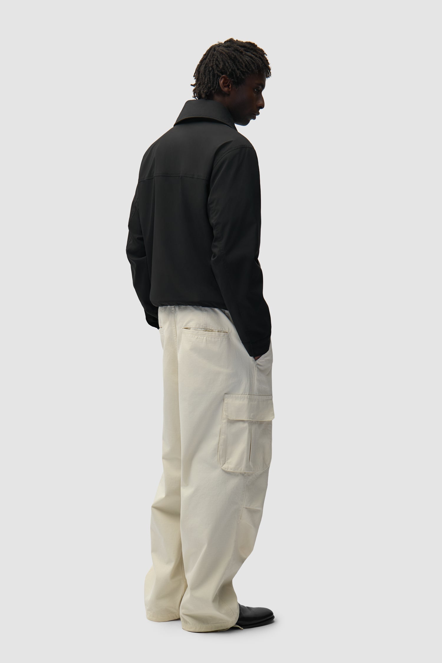 Big Collar Nylon Jacket in Black worn by a model, full-body back view