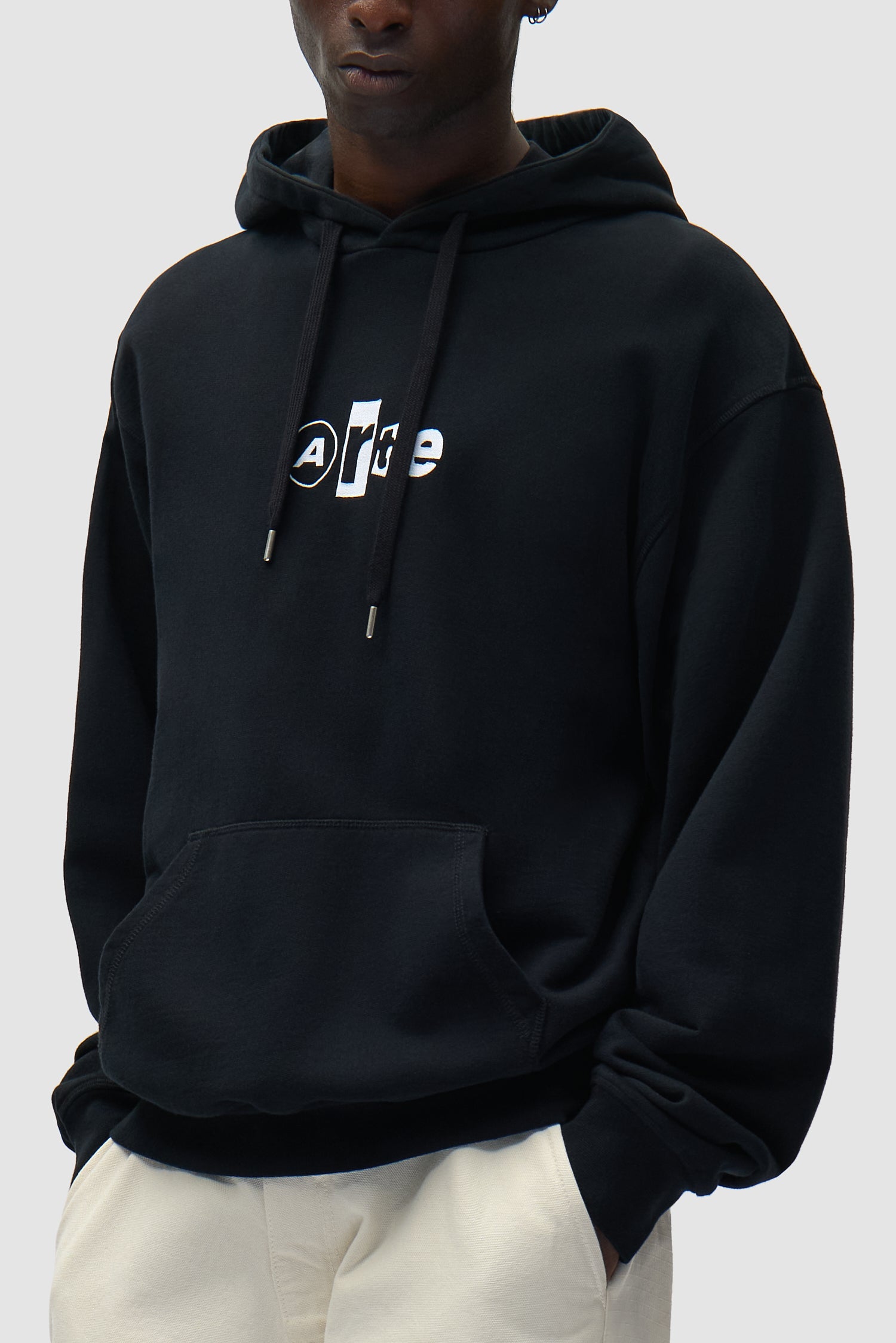 Collage Logo Hoodie in Black worn by a model, half-body side view