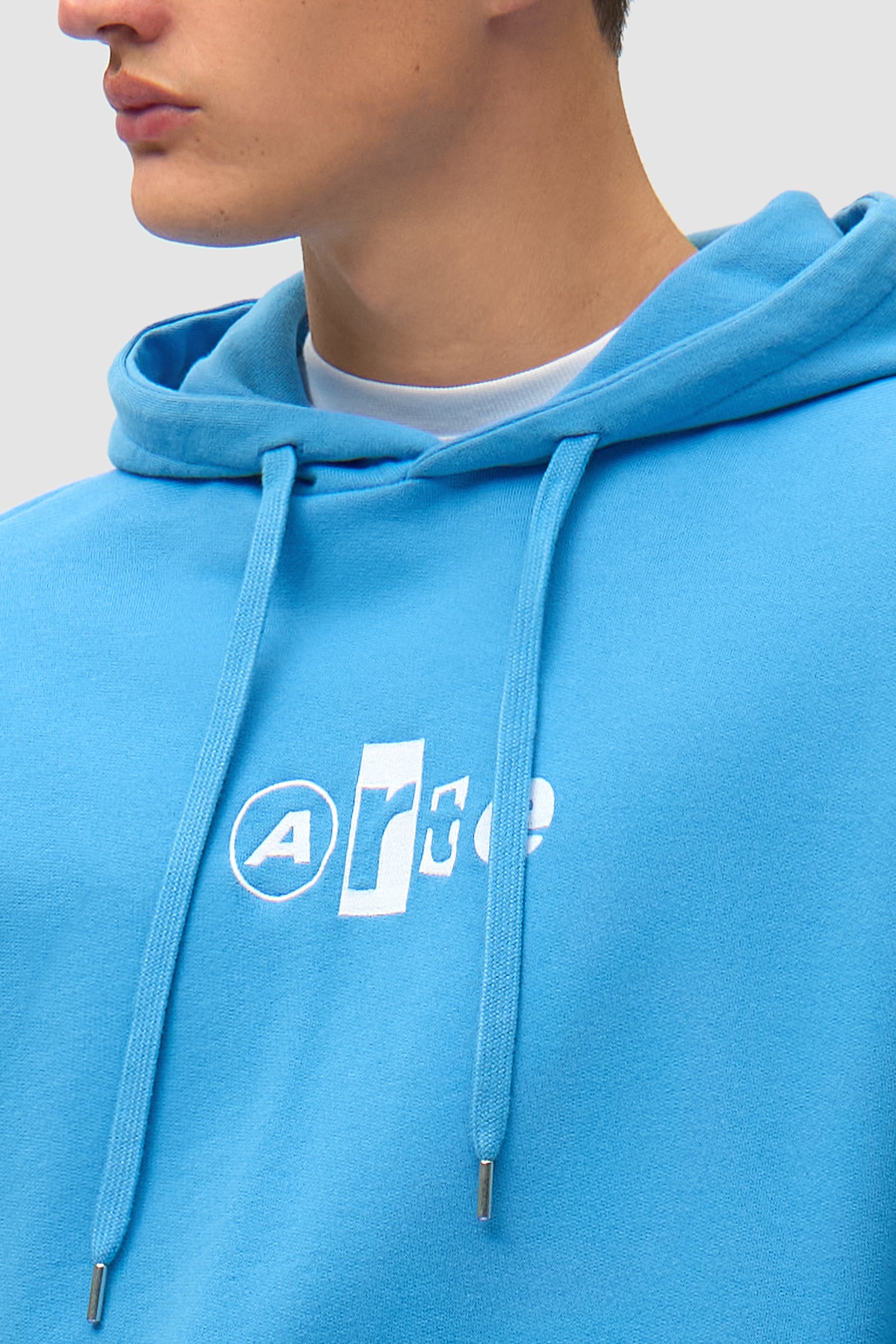 Detail view of Collage Logo Hoodie in Blue, showing logo