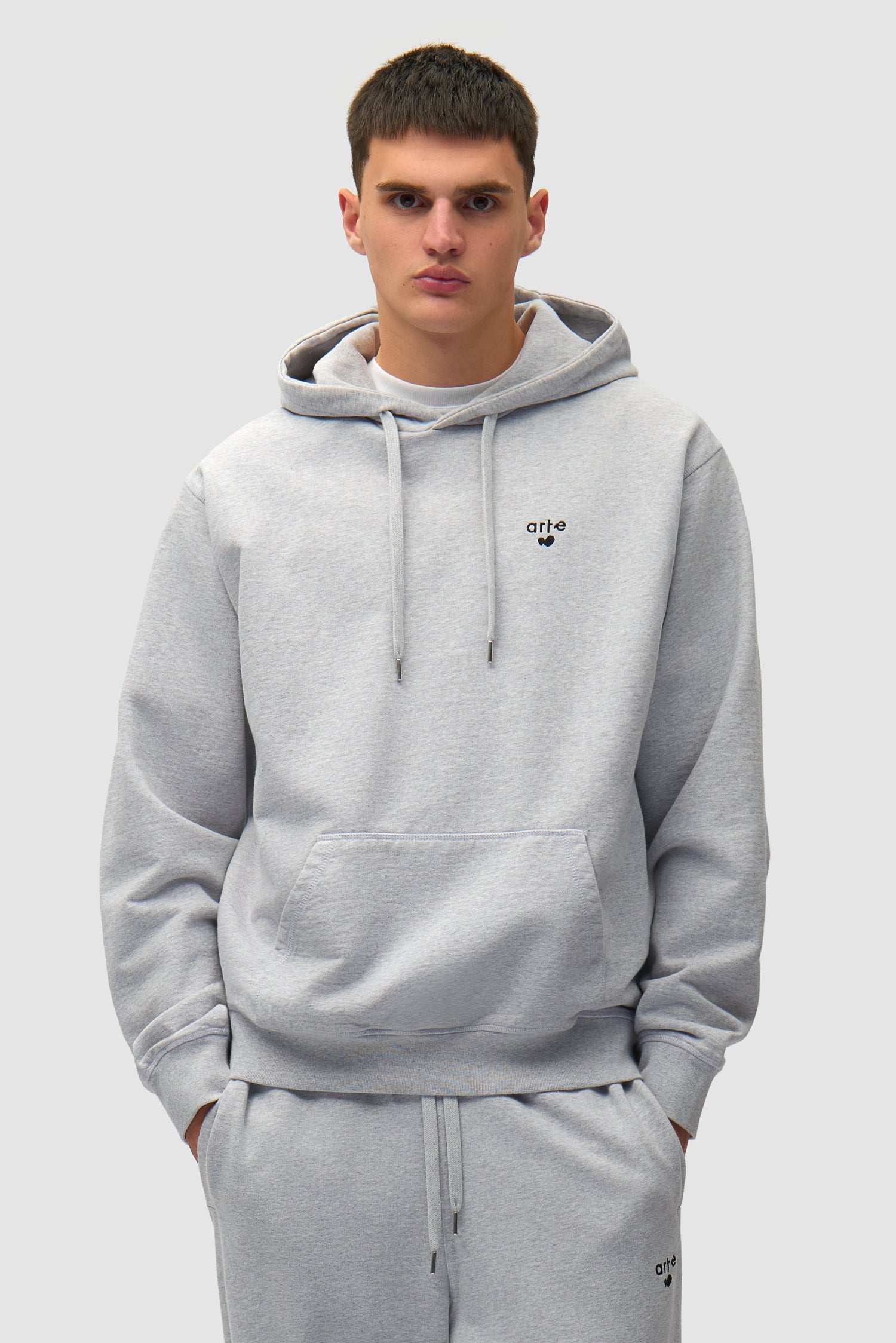 Heart Logo Hoodie in Grey worn by a model, half-body front view
