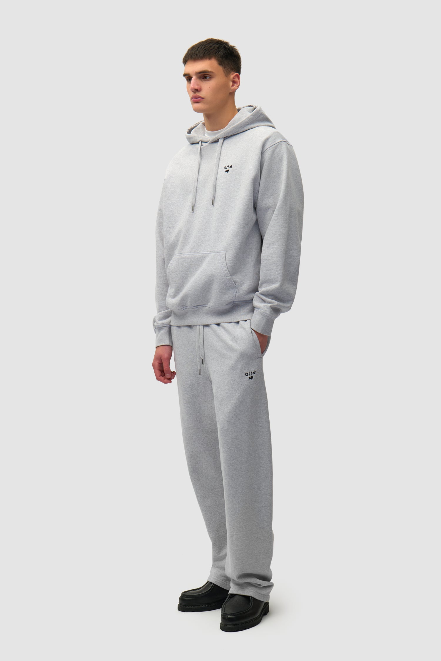 Heart Logo Hoodie in Grey worn by a model, full-body front view