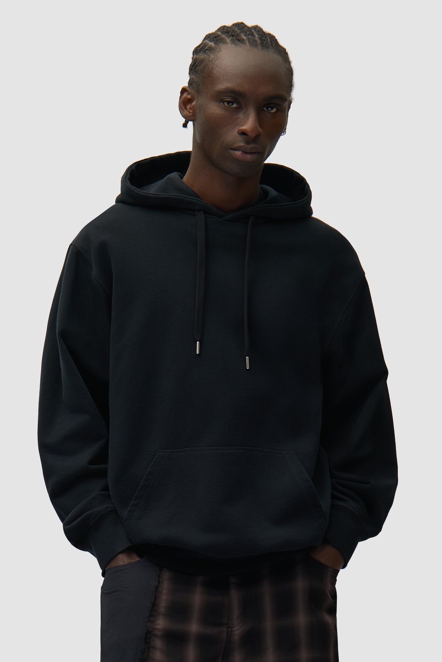 Back Abstract Hoodie in Black worn by a model, half-body front view