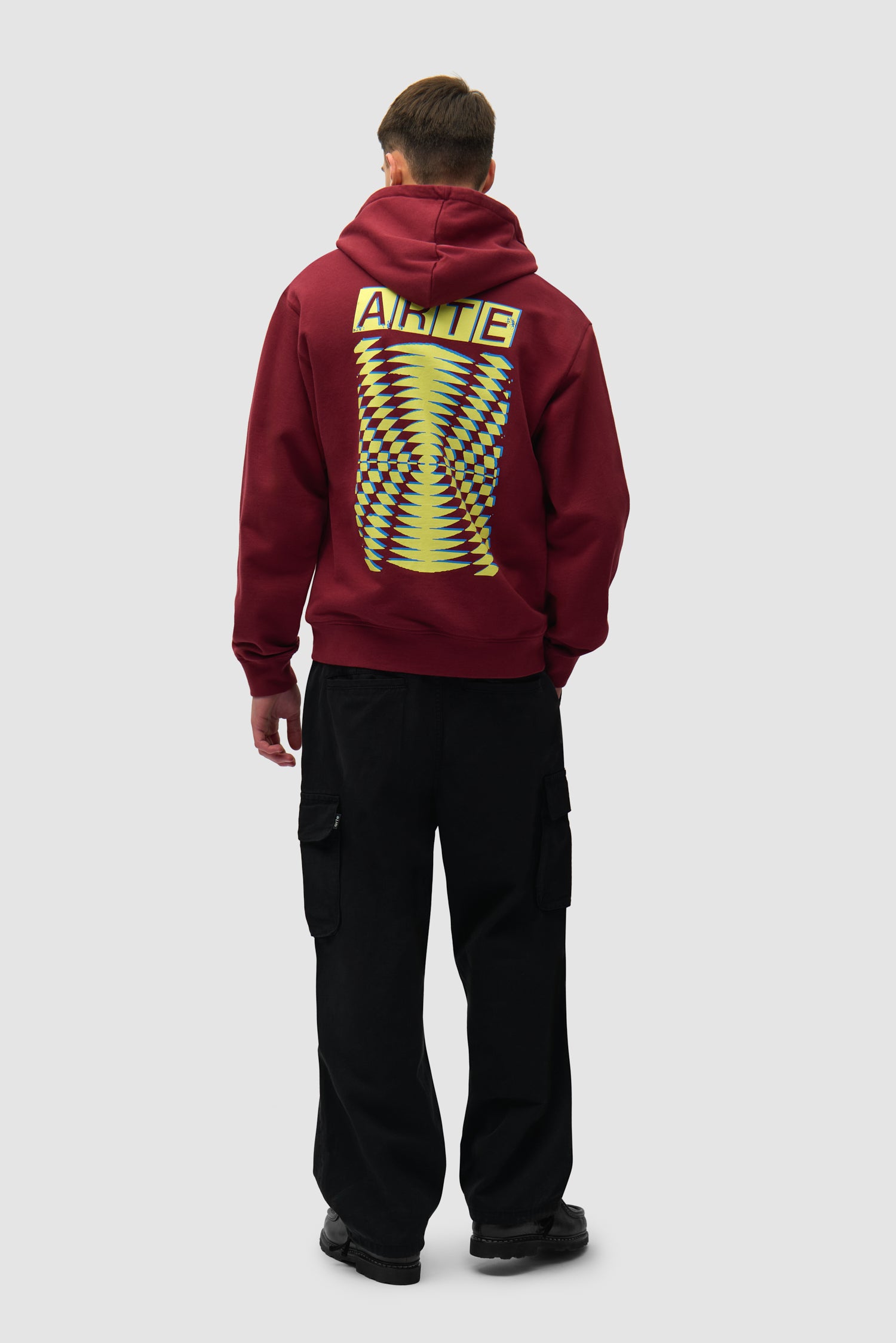 Back Abstract Hoodie in Bordeaux worn by a model, full-body side view