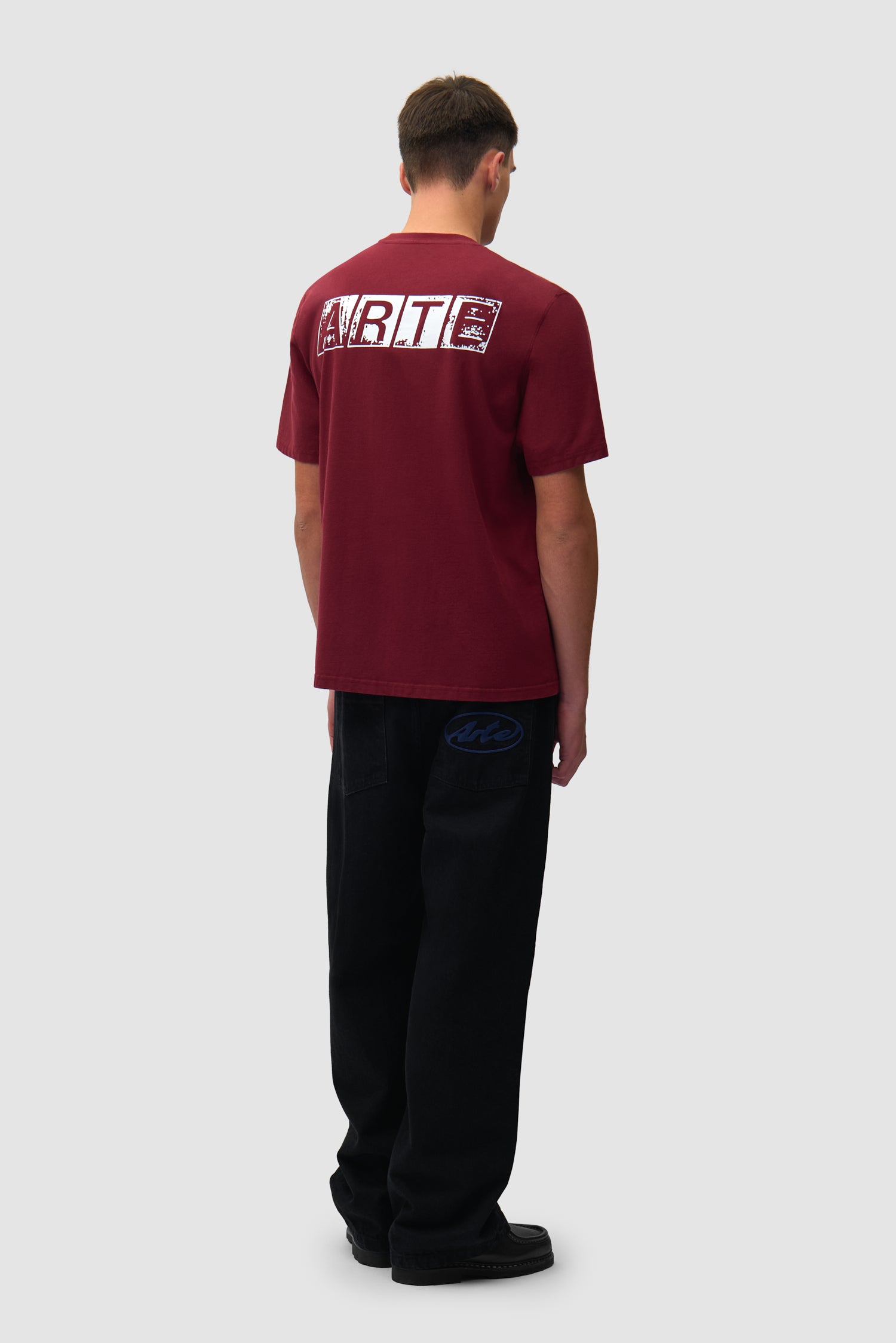 T-shirt à imprimé délavé dans le dos, couleur bordeaux, porté par un mannequin, vue de profil en pied