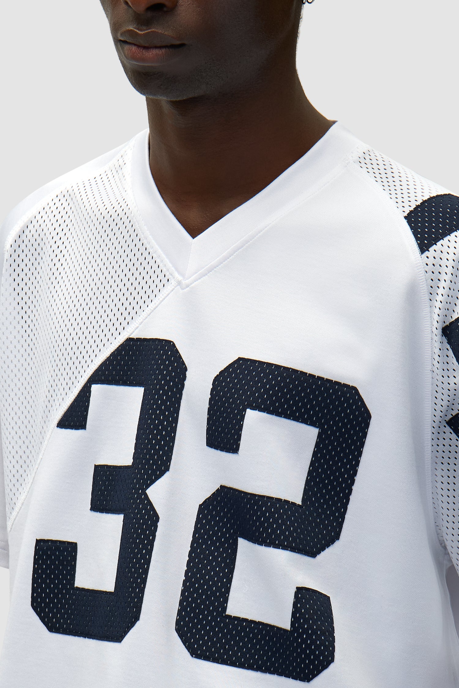 Vue détaillée du maillot n° 32 bleu marine/blanc, avec les numéros sur le devant