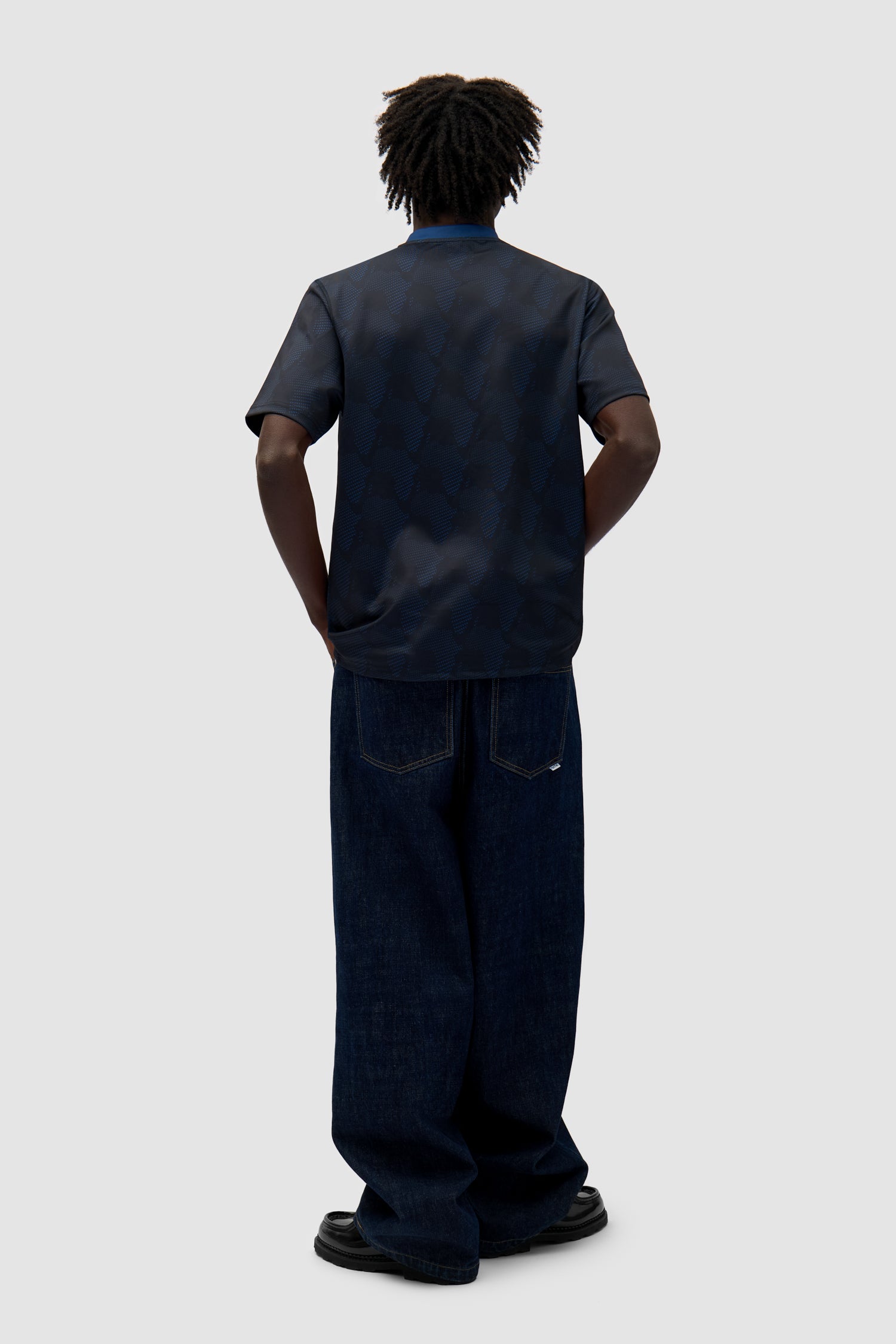 Footbal Shirt in Navy worn by a model, full-body back view