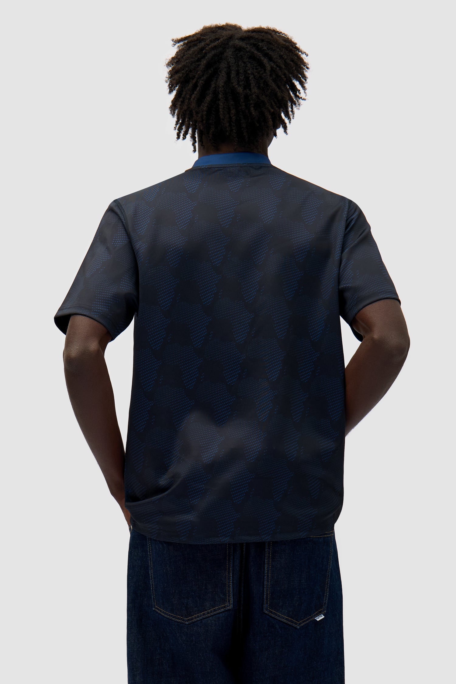 Footbal Shirt in Navy worn by a model, half-body back view