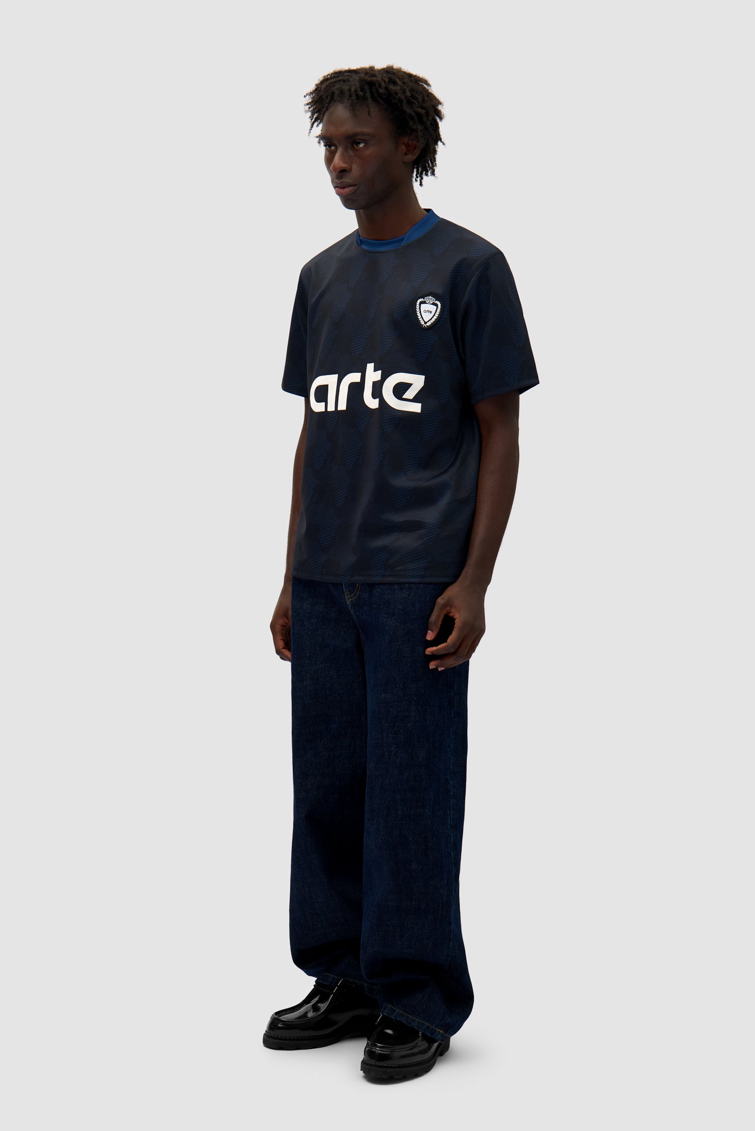 Footbal Shirt in Navy worn by a model, full-body side view