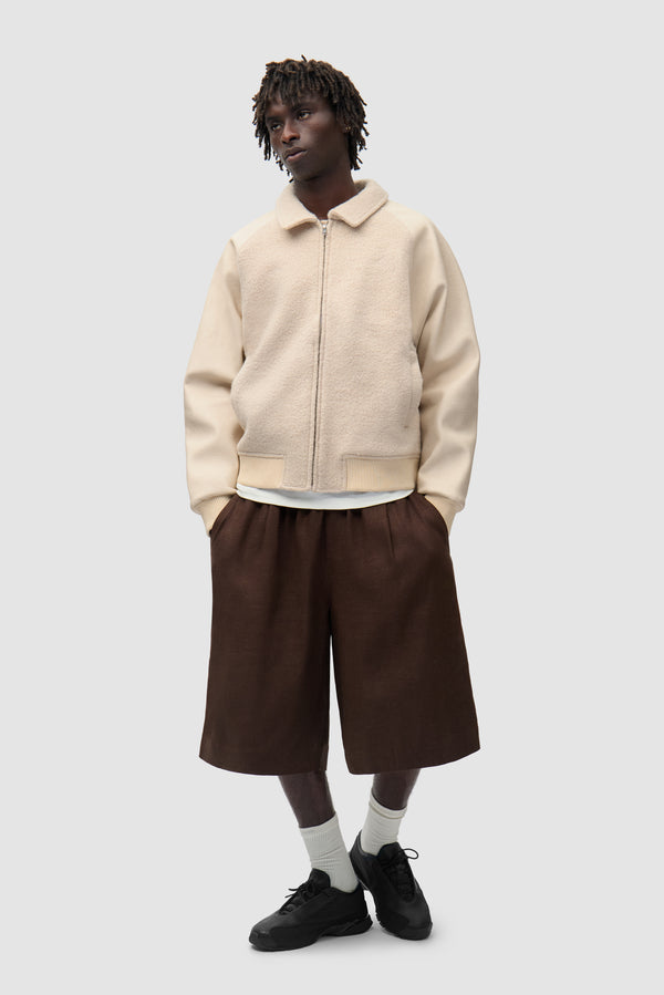 Arte for adidas Varsity Jacket - Cream worn by a model, full-body front view