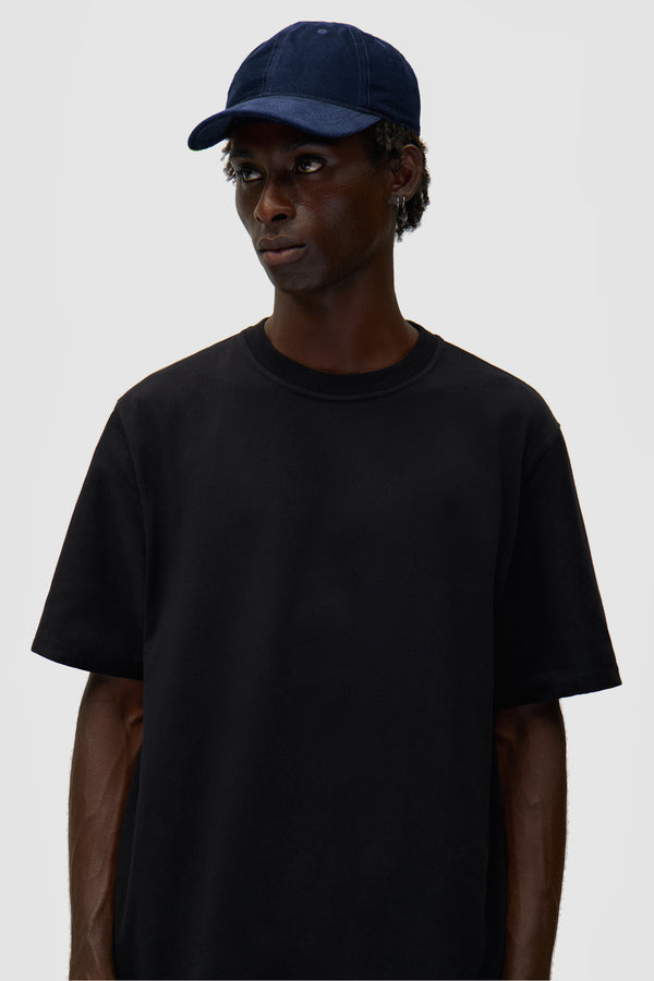 Corduroy Cap in Navy worn by a model, half-body front view