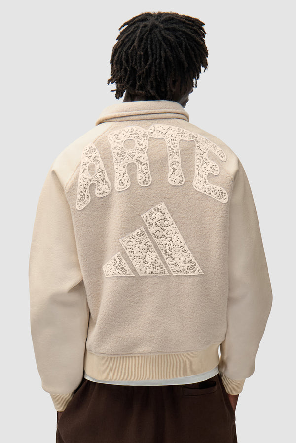 Arte for adidas Varsity Jacket - Cream worn by a model, full-body back view