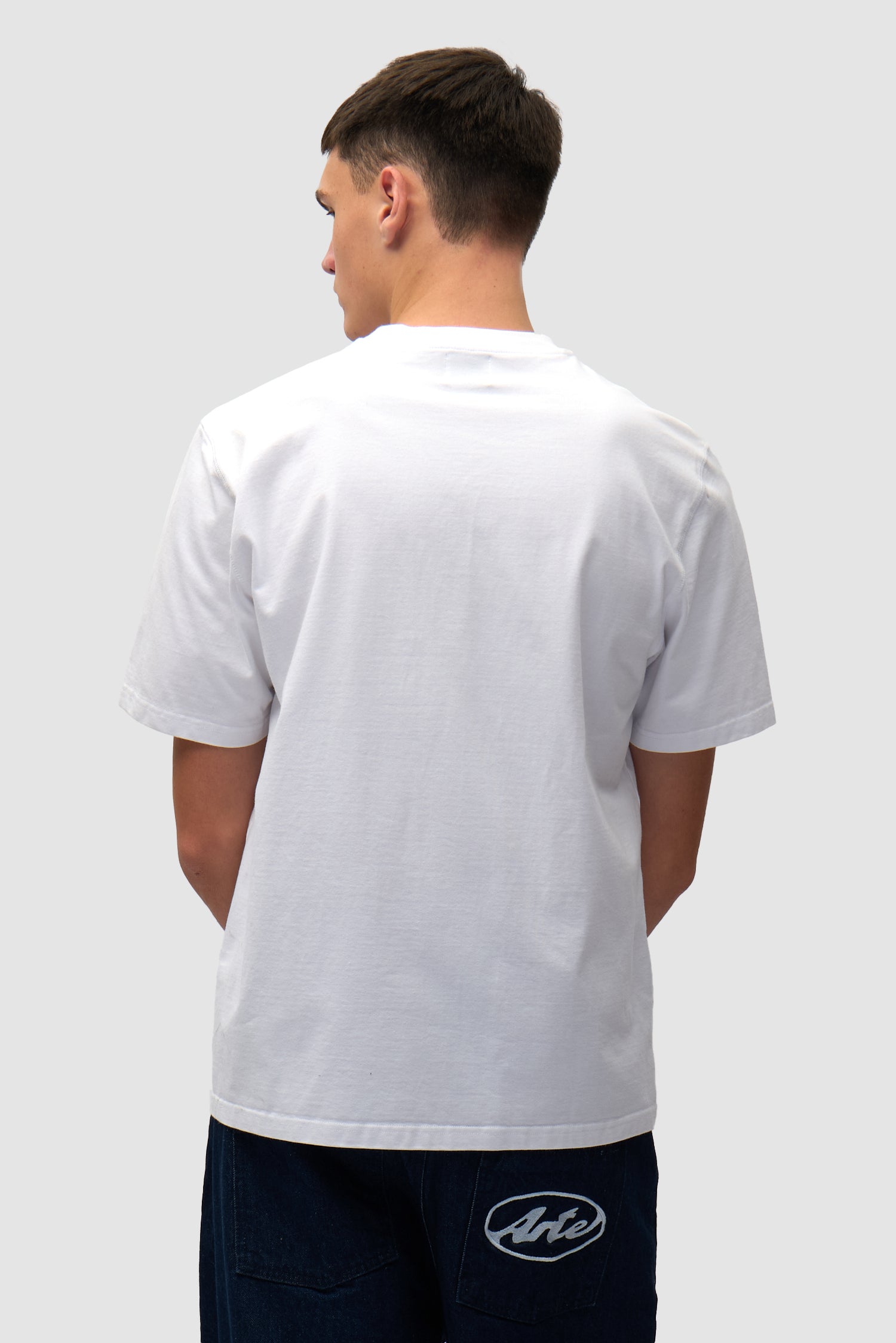 T-shirt blanc avec logo en forme de cœur porté par un mannequin, vue de dos à mi-corps