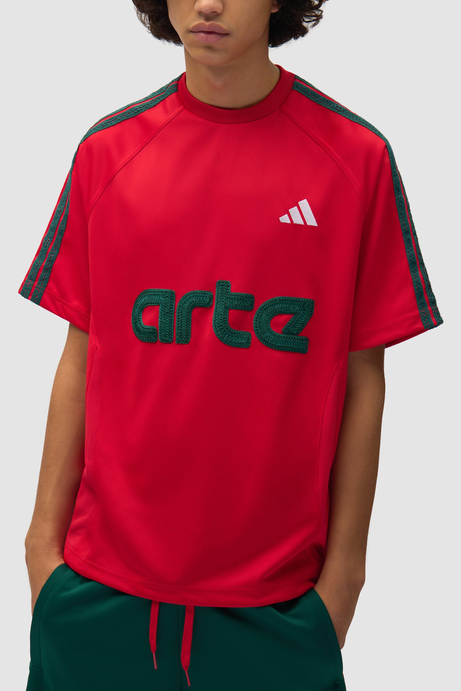 Arte for adidas Jersey in Better Scarlet worn by a model, half-body detailed view