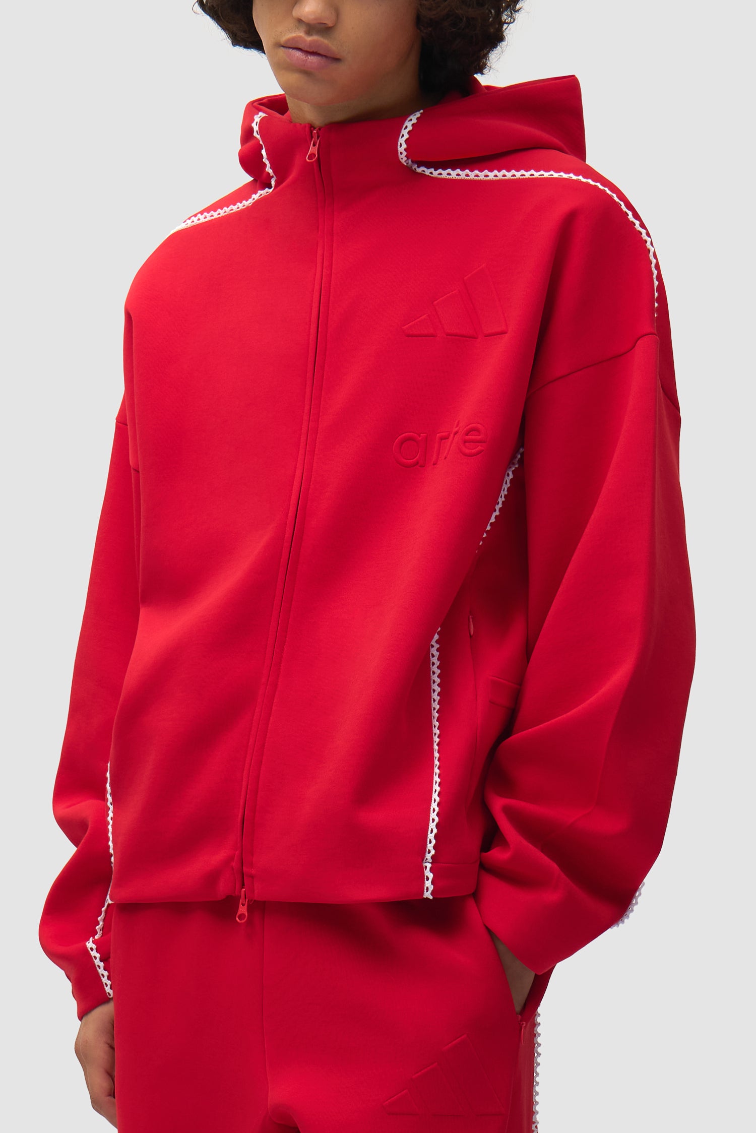 Veste Arte pour adidas Z.N.E. en Better Scarlet/White portée par un mannequin, vue détaillée du haut du corps