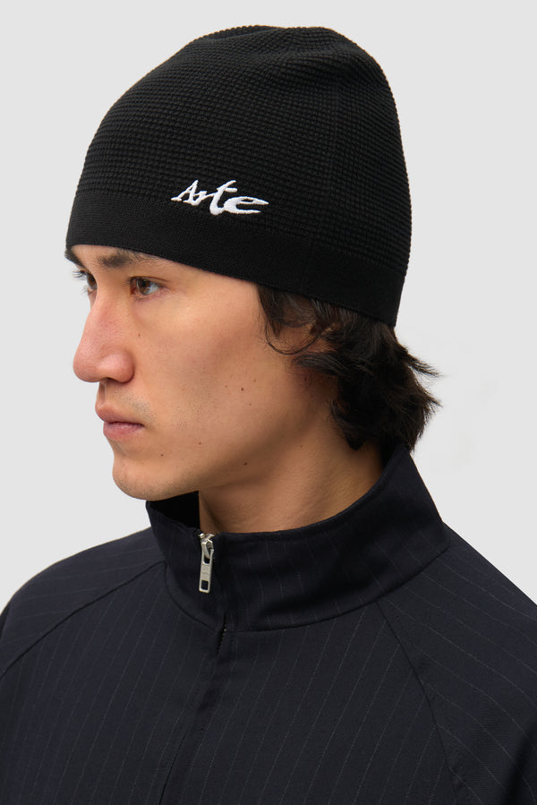Beanie in Black worn by a model, half-body side view
