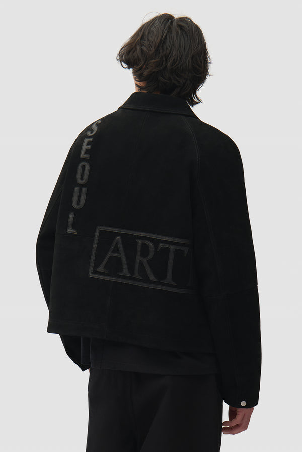 Leather Patches Jacket in Black worn by a model, half-body back view