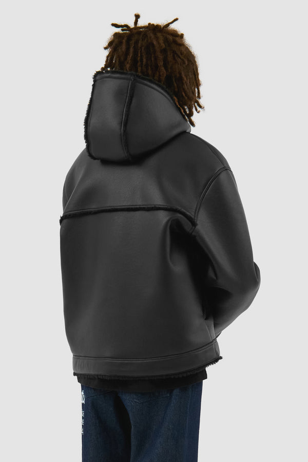 Shearling Jacket in Black worn by a model, half-body back view